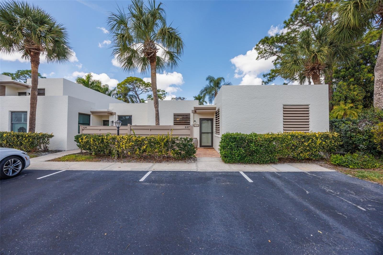 A beautiful lower level condo, end unit, giving you, the new owner more privacy. Comes with covered "deeded" parking. Completely updated with new kitchen shacker cabinets, granite counter tops and luxury vinyl plank flooring thru out. Both bathrooms have been removated. Newly painted. This units feels like a private villa, with a walled-in courtyard (25' x 10') with new pavers, just off the glassed-in lanai, for additonal living space. Both bedrooms are en-suites and both have walk-in closets. This community is close to everything you will need for that Florida Lifestyle living.  8 miies to the incredible Island of Anna Maria!  Close to shopping, restaurants, theatres, doctors offices and 2 major hospitals.  A mere 20 minutes to Sarasota/Bradenton International Airport, 45 Minutes to Tampa Bay International Airport. Management is on-site. Maintenance free living, with low maintenance fees that include water, sewer, pest control, internet service, cable TV and outside maintenance.  7 "heated" pools, jacuzzi, tennis and pickle ball counrts.