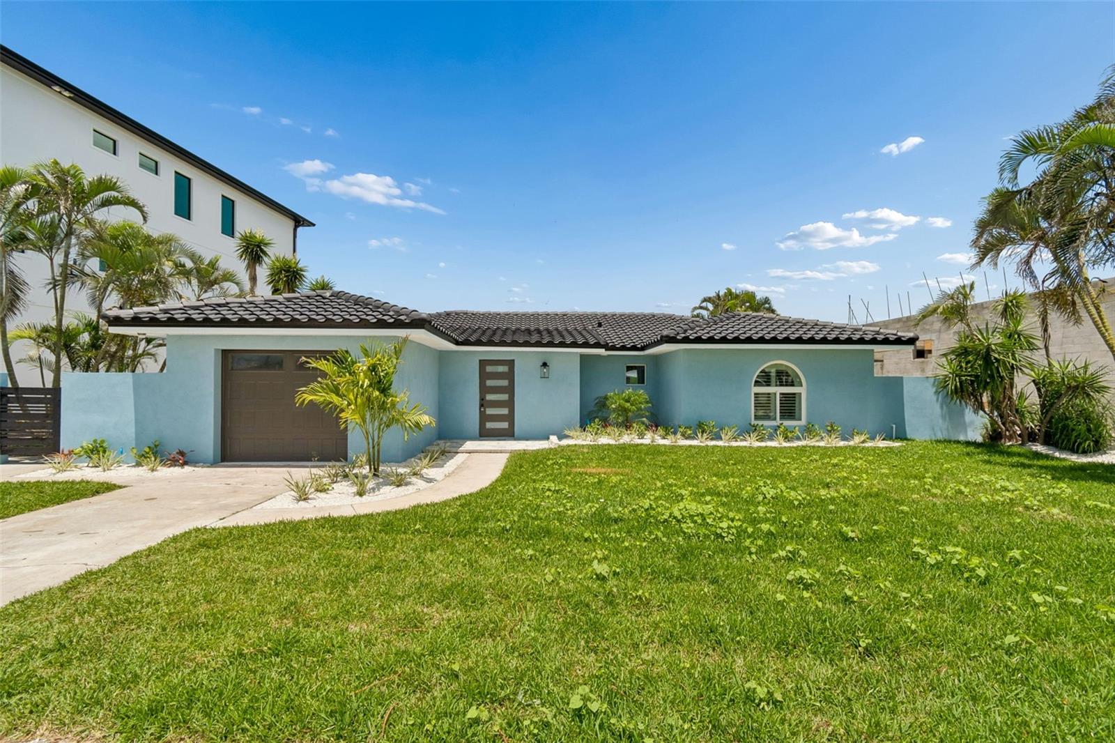 Experience the pinnacle of refined waterfront living in this impeccably renovated residence situated within the highly sought-after Paradise Island community, just minutes from the pristine Gulf beaches of Treasure Island. Originally constructed in 1955, this sophisticated coastal retreat has been thoughtfully reimagined from top to bottom, seamlessly blending timeless architectural character with elevated contemporary finishes and modern functionality. Offering 3 bedrooms, 2 bathrooms, and 2,151 square feet of meticulously curated living space, the home showcases an extensive list of premium upgrades and high-quality craftsmanship throughout. Upon entry, you are welcomed by expansive open-concept interiors featuring Level 5 smooth-finish walls and ceilings, new interior and exterior doors, custom trim work, upgraded hardware, and designer lighting selections that create a clean, sophisticated aesthetic. The fully renovated chef’s kitchen is appointed with custom cabinetry, quartz countertops, designer hardware, and a complete suite of new appliances, while matching quartz window sills throughout the residence further elevate the cohesive luxury design palette. The bathrooms have been completely transformed with stunning new tile showers, updated plumbing fixtures, LED vanity mirrors, modern toilets, and a newly installed cast-iron soaking tub, creating spa-inspired spaces designed for comfort and relaxation. Additional infrastructure and mechanical enhancements include hydro-jetted sewer lines, a newly installed sewer backflow preventer, updated plumbing fixtures and drains, new electrical outlets, switches, lighting, exhaust fans, and comprehensive electrical testing for peace of mind. The exterior living environment has been equally enhanced to maximize the Florida waterfront lifestyle. The property features fresh exterior stucco and paint, newly installed paver patios and walkways, professionally refreshed landscaping, updated irrigation components and timer systems, as well as a renovated waterfront dock complete with new joists and decking — ideal for boating enthusiasts and outdoor entertaining alike. The garage has also been upgraded with new drywall and an epoxy-style painted floor finish for a polished appearance. Perfectly positioned within close proximity to Treasure Island Beach, waterfront dining, marinas, and vibrant coastal amenities, this exceptional Paradise Island residence presents a rare opportunity to acquire a truly turn-key waterfront home where every detail has been carefully considered and masterfully executed. Don’t miss this exceptional opportunity to own a beautifully upgraded home in one of Treasure Island's most desirable neighborhoods. Schedule your private showing today and experience all this remarkable property has to offer.
