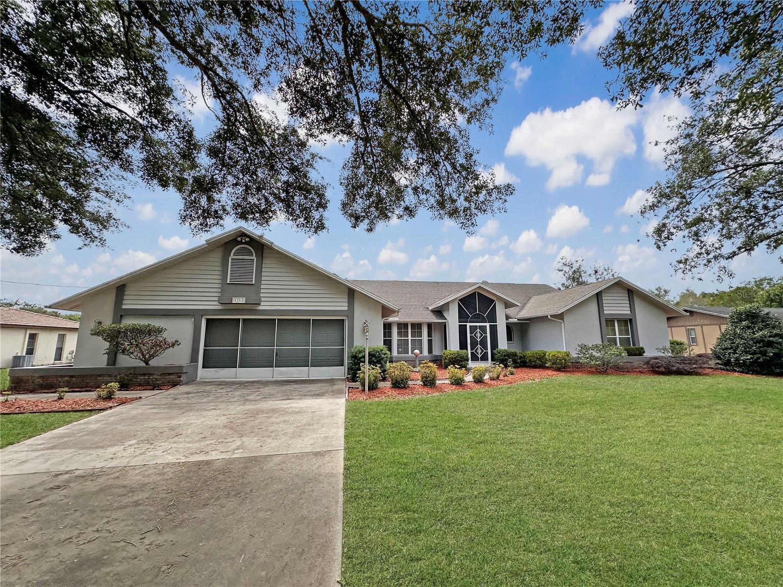 One or more photo(s) has been virtually staged. Welcome to your own private Florida retreat just minutes from Weeki Wachee Springs State Park! This spacious 4-bedroom, 2.5-bath pool home offers 2,830 square feet of beautifully designed living space on an oversized 22,100 sq ft PVC-fenced lot surrounded by mature landscaping and two stunning grand oak trees. Step through the solid wood double entry doors and enjoy immediate views of the sparkling pool and screened lanai. The split floor plan provides privacy and flexibility, with two bedrooms on each side of the home. The spacious primary suite includes peaceful pool views, private access to the lanai, a massive walk-in closet, dual sinks, Jacuzzi tub, walk-in shower, and private water closet. An additional bedroom on the primary side makes the perfect office, nursery, or flex space. Designed for entertaining, the family room opens seamlessly to the screened pool area through sliding pocket doors, creating the ultimate indoor-outdoor Florida lifestyle. The kitchen features stainless steel appliances, breakfast bar seating, double sink, pass-through window to the pool area, and additional serving access overlooking the living room fireplace and pool views. Enjoy both a formal dining room with bay windows and a casual dining nook with additional pocket sliders opening to the lanai. The screened outdoor living area includes a covered lanai and outdoor kitchen space overlooking the private pool and expansive backyard. The second full bath conveniently serves as a pool bath between the guest bedrooms. A cozy brick gas fireplace anchors the living room, creating warmth and charm throughout the home. There is a large laundry room going into the two car garage with a built-in workshop. This property combines space, privacy, and classic Florida living in one incredible location near nature, springs, kayaking, and outdoor recreation.