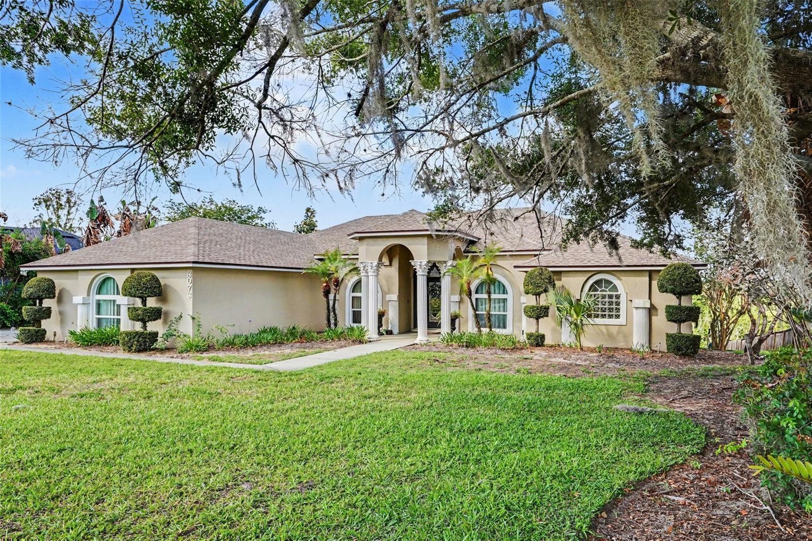 Experience exceptional waterfront living in this beautifully maintained Mediterranean-style residence located on Little Lake Hamilton. Situated on a spacious half-acre lot, this 4-bedroom, 3-bath home offers approximately 2,640 square feet of thoughtfully designed living space with direct canal access to the Chain of Lakes.

Inside, you'll find elegant travertine marble flooring, granite countertops, stainless steel appliances, a wine refrigerator, and expansive living areas designed to maximize stunning water views. The primary suite, family room, living room, kitchen, and pool area all overlook the lake, creating a seamless connection between indoor and outdoor living. A cozy wood-burning fireplace adds warmth and character to the family room.

Step outside to your private backyard retreat featuring a sparkling in-ground pool, spacious pool deck, mature tropical landscaping, and a private dock along a deep-water canal. Whether enjoying a quiet sunset or entertaining guests, this property offers the ideal Florida waterfront lifestyle. Additional features include a two-car garage, solid masonry construction, and access to boating, fishing, and water sports right from your backyard.

A rare opportunity to own a premier waterfront home in the desirable Lakeview Landings community.