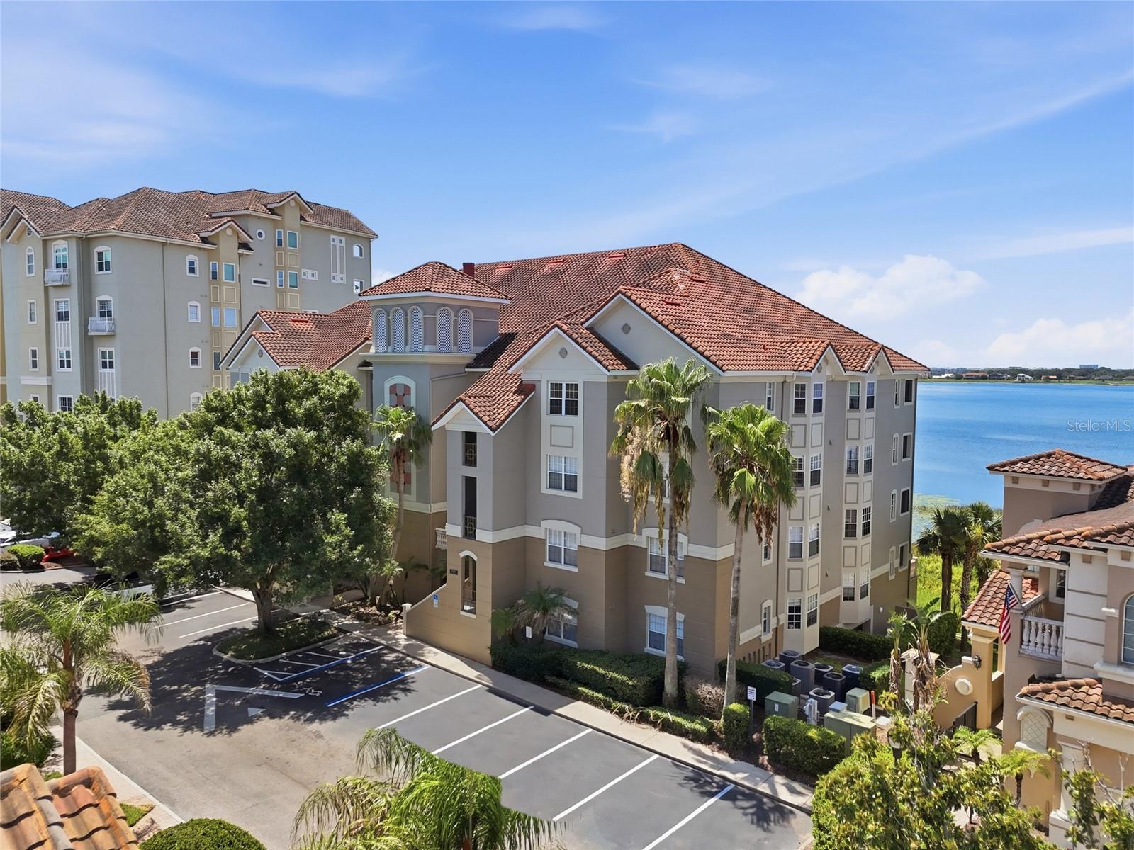 Experience luxury lakefront living in the heart of Dr. Phillips at the highly sought after Vizcaya Heights Condominiums. This exceptional third floor end unit offers over 2,300 square feet of beautifully designed living space with breathtaking panoramic views of Big Sand Lake and nightly Disney fireworks from your private covered balcony.

Designed with both comfort and elegance in mind, this spacious 3 bedroom, 2 bath residence features a desirable split bedroom floor plan, oversized bedrooms, formal living and dining rooms, a family room, and an abundance of natural light pouring through numerous windows that showcase spectacular sunrises, sunsets, and serene water views. Move in ready, the home is enhanced with tile flooring throughout, coffered ceilings, custom architectural niches, plantation shutters, elegant chandeliers, generous storage, custom closet systems, and a spacious laundry room.

The centrally located kitchen is equipped with stainless steel appliances, offering an ideal layout for everyday living and entertaining. The private primary suite serves as a true retreat, featuring direct balcony access, expansive his and hers closets, double vanities, a soaking tub, and a large walk in shower.

This exclusive building offers added privacy with only 16 residences, compared to many neighboring buildings with 24 or more units. The home also includes an assigned underground garage parking space with a private storage room, elevator access directly to the third floor, and ample guest parking.

Vizcaya is one of Central Florida's premier Mediterranean inspired, 24-hour guard gated communities, surrounded by the beauty of Big Sand Lake, Little Sand Lake, and Lake Serene. Residents enjoy resort style amenities including two swimming pools, spa, fitness center, tennis and pickleball courts, two clubhouses, a brand new playground, scenic walking paths, and beautifully maintained landscaping.

The HOA provides exceptional value by covering exterior building maintenance, roof maintenance, landscaping, water, trash, cable, and internet, allowing for a truly maintenance free lifestyle.

Perfectly located just minutes from Orlando's renowned Restaurant Row, upscale shopping, major attractions, International Drive, Universal Orlando, SeaWorld, Walt Disney World, and Orlando International Airport, this home offers the ideal combination of tranquility, luxury, and convenience.

Whether you're enjoying peaceful lakefront mornings, spectacular sunsets, or fireworks from your balcony, this remarkable residence offers a lifestyle that is simply unmatched.