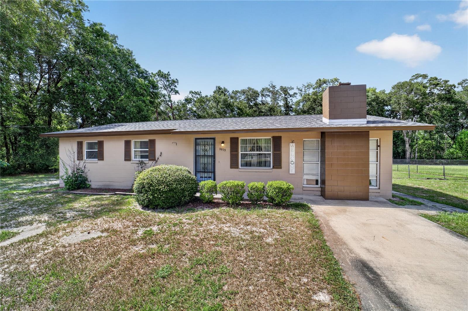Charming Country Setting on 2/3 Acre – No HOA! Escape the ordinary in this inviting North Ocala home nestled in a casual country setting on a generous 2/3-acre lot. With a brand-new 2025 roof and freshly painted exterior, this 3-bedroom, 2-bath residence is move-in ready and full of space to spread out and enjoy life.  Inside, you'll find room for everyone — a welcoming living room, a cozy family room anchored by a fireplace, and a versatile enclosed Florida room perfect as a home office, playroom, or relaxation retreat. The open kitchen features an island with ample counter space and abundant storage, making it ideal for everyday living and entertaining alike. A convenient indoor laundry room completes the interior.  Step outside to a screen-enclosed lanai, perfect for enjoying Florida's weather year-round. Two storage sheds provide plenty of room for tools, equipment, and all your outdoor toys — and with no HOA, you have the freedom to truly make this property your own. Ideally situated for an easy commute to both Gainesville and The Villages, this home offers the best of peaceful country living without sacrificing convenience.  Ready for immediate occupancy — come see it today!