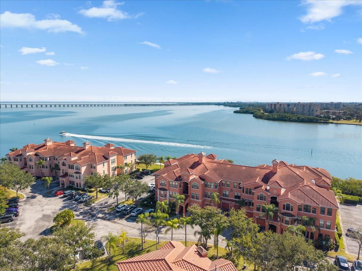 Stop your search! Experience resort-style living at Grand Venezia at Baywatch, Clearwater's premier gated waterfront community on Tampa Bay. This condo is in building 11, at the end of a peninsula. There is 24-hour guarded security crew here, adored by residents. HIGHLIGHTS: Your own Full-size washer/dryer room inside the unit. EASY drives to the beaches and airports. Could be an ideal investment with 30 day minimum leases allowed. HIGHLIGHTS of THIS condo: Brand new A/C. Newer Washer, newer Washing Machine and newer Garbage disposal under kitchen sink.  

This spacious 2-bedroom, 2-bath residence features an open-concept floor plan with soaring 9-foot ceilings, elegant tray ceilings with crown molding, granite countertops, luxury vinyl flooring, and a full-size interior laundry room. 

This community is known for its outstanding amenities, including a heated pool with cabanas and hot tub, fitness center, tennis courts, volleyball sand court, car wash station, clubhouse, and a scenic 1.5-mile waterfront walking trail that surrounds the community.

Perfectly positioned just off US-19 and Belleair Road, Grand Venezia offers easy access to Tampa, St. Petersburg, Clearwater Beach, and two international airports—all within approximately 25 minutes. Costco, Target, Sams Club are just minutes away.

If you're looking for a condo, in Pinellas County, move in ready, tall ceilings, no flooding from any storms, top floor so no-one walking above you, where you can soak up the sun and Florida lifestyle- this is it. Book your showing today and hope to see you soon.