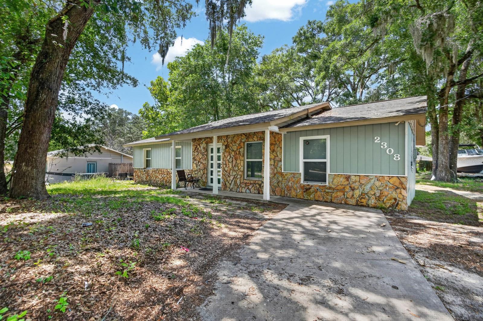 Welcome to 2308 NE 35th Street, Ocala! A charming home nestled beneath mature oak trees on a spacious lot, offering the perfect blend of comfort, privacy, and convenience. Whether you're a first-time homebuyer, investor, or simply looking for more space to spread out, this property delivers endless potential in an established neighborhood.

Inside, you'll find a functional layout featuring a generously sized living area, durable laminate flooring throughout the main living spaces, and a bright kitchen with ample cabinetry, stainless steel appliances, and plenty of counter space for everyday cooking and entertaining. The adjoining dining area overlooks the expansive backyard through French doors, creating a seamless indoor-outdoor living experience.

The primary suite includes an en-suite bathroom and ample closet space, while the additional bedrooms provide flexibility for family, guests, or a home office. Outside, the oversized backyard is shaded by beautiful mature trees and offers plenty of room for pets, gardening, outdoor entertaining, or future additions. A storage shed adds extra space for tools and equipment.

Conveniently located just minutes from shopping, dining, schools, medical facilities, and downtown Ocala, this home combines everyday convenience with a peaceful setting. Don't miss this opportunity to own a property with space, character, and room to make it your own!