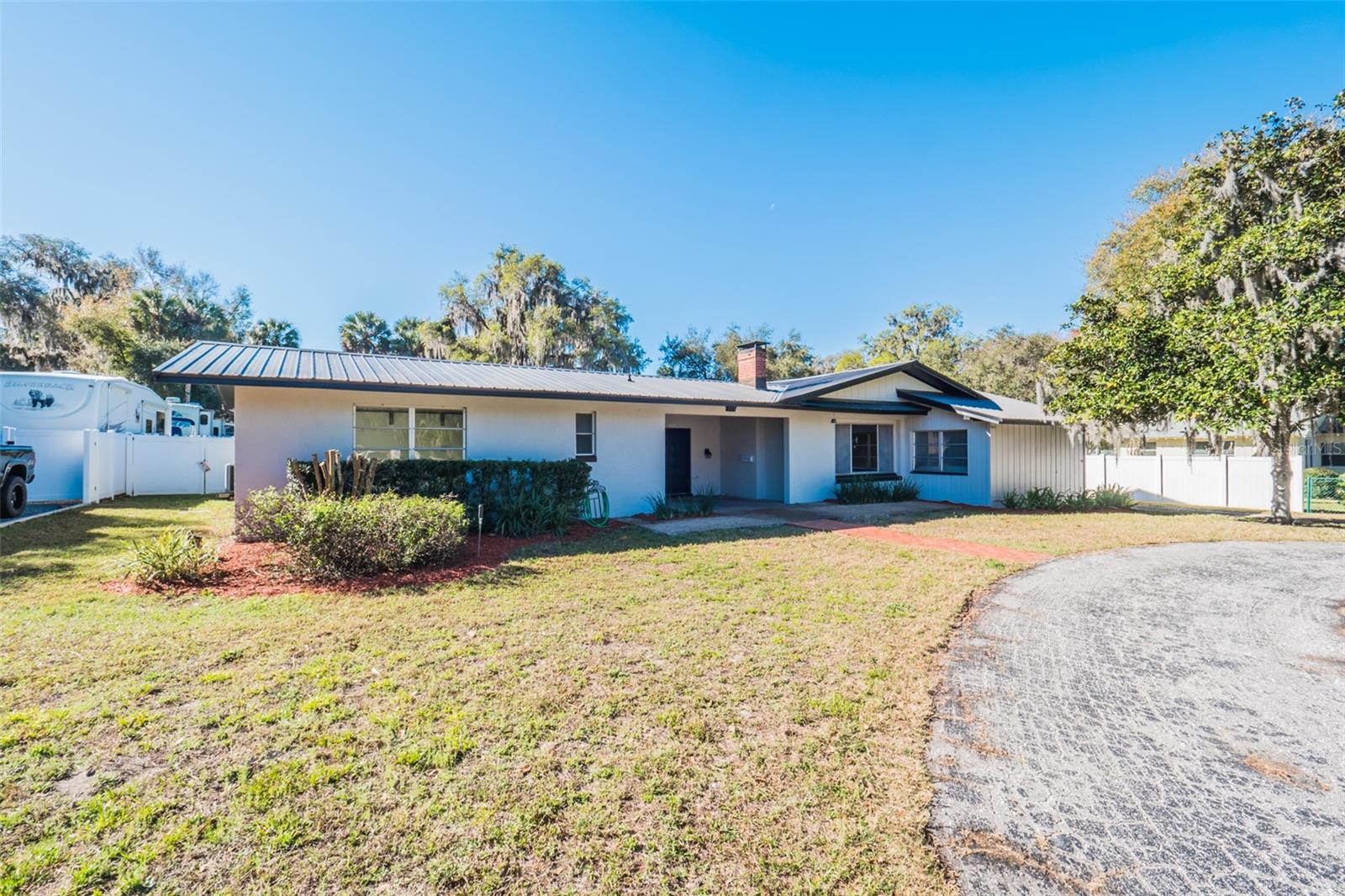 PRICE REDUCED! This unique Pool Home located in the beautiful and highly sought after "Palmora Park" community, needs complete updating but has a lot of potential. With your vision you can make this home into something special. The home has a new metal roof installed in 2022 and a PV Solar 33 panel roof mount system. Sitting on almost half an acre, the property has plenty of space for a family to play, relax and offers plenty of space to store your outdoor toys. The home features formal a living room with fireplace, a formal dining room and a large family room all with hardwood flooring. The kitchen includes a large walk-in pantry and a separate dinette area. The large bonus covered patio room has many possibilities. The guest/in-law apartment features a large suite and bathroom. Relax in the backyard pool or greenhouse. The beautiful Venetian Gardens is close by offering a lakeside restaurant, marina, and walking trails. Historic Downtown Leesburg with restaurants, bars and shops is only a few minutes away. PRESENT YOUR OFFER TODAY!