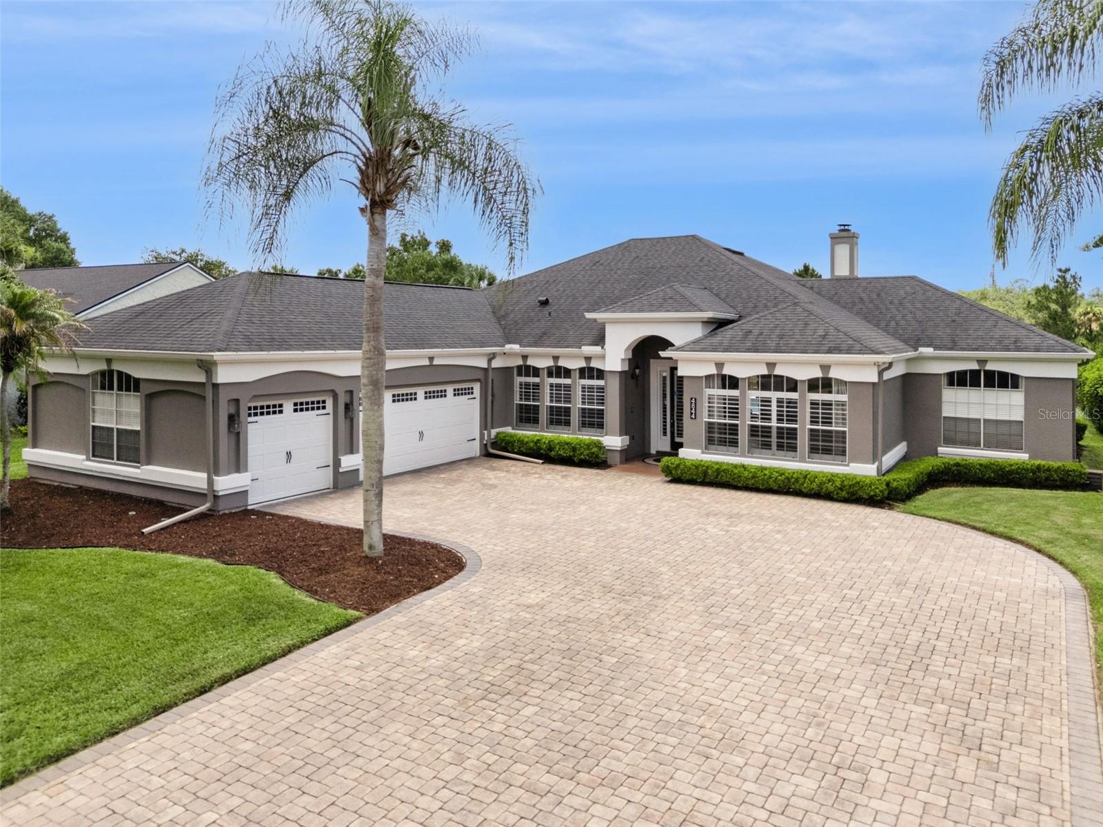 Welcome to this beautifully renovated pool home in the highly desirable Yorkshire section of University Estates. Boasting 4 bedrooms, 2 bathrooms, 2,530 square feet of living space, and a full 3-car garage, this home sits on a premium homesite overlooking tranquil water and conservation views, creating a private backyard retreat that's hard to find. ROOF 2020, Water Heater 2026. From the moment you enter, stunning wood-look tile flooring and plantation shutters throughout set the tone for the extensive upgrades found throughout the home. Formal living and dining spaces provide flexibility for entertaining, while the open-concept design seamlessly connects the kitchen and family room, making this home ideal for everyday living and hosting guests. The completely remodeled kitchen is the centerpiece of the home, featuring white cabinetry with black hardware, a contrasting two-tone island, quartz countertops, designer tile backsplash, stainless steel appliances, custom range hood, pop-up outlet with USB charging, built-in storage solutions, and a charming breakfast nook with built-in seating and storage. The spacious family room offers custom floating wood shelving surrounding a beautiful wood-burning fireplace while overlooking the pool and backyard. The split-bedroom floor plan provides privacy for everyone. The oversized primary suite occupies its own wing of the home and features French doors leading directly to the covered lanai and pool area. Double doors open into the luxurious primary bathroom, complete with separate granite-topped vanities, a large soaking tub, and a spacious glass-enclosed shower. Also located on the primary wing is an additional bedroom that works perfectly as a guest room, nursery, home office, or flex space. On the opposite side of the home, two generously sized bedrooms share an updated bathroom featuring dual granite vanities, upgraded mirrors, lighting, faucets, and cabinet hardware. This bathroom also serves as a convenient pool bath with direct access to the outdoor living area. Step outside to the true highlight of the property—a massive covered lanai overlooking a beautiful electric-heated pool and spa. Beyond the pool, you'll enjoy a larger backyard with peaceful water views and conservation behind, creating a picturesque setting for entertaining, relaxing, and enjoying Florida living year-round. Additional features include a smart thermostat, hard-wired security system with motion sensors and four exterior cameras, an intercom system, built-in kitchen storage drawers and custom silverware organizers. The oversized 3-car garage features custom overhead storage racks and ample room for vehicles, recreational equipment, a workshop, or home gym. Combined with extensive renovations, resort-style outdoor living, and premium water and conservation views, this property offers the perfect blend of comfort, functionality, and location. Exterior paint 2022. *Transferrable Termite Bond*. Perfectly positioned just minutes from UCF, the UCF football stadium, Research Parkway, and SR-417, this home offers exceptional convenience for professionals and anyone looking to be close to everything East Orlando has to offer.