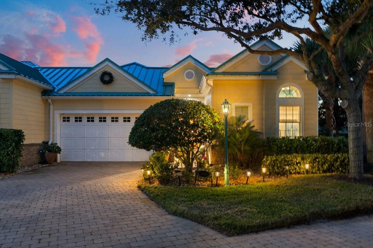 Welcome to the crown jewel of Harbour Village—this exceptional model courtyard villa delivers resort-level luxury, privacy, and timeless design at every turn. Showcasing 5 bedrooms, 5 baths, a private office, pool, and spa, this fully customized residence was built to impress, with every bell and whistle you'd expect from a former model home. At the heart of the villa lies a gated, expansive courtyard, designed as a private tropical retreat, featuring a spectacular waterfall pool and spa surrounded by lush landscaping—perfect for entertaining or quiet relaxation. The courtyard screen enclosure & the ROOF were fully redone in 2023, enhancing both comfort and aesthetics. As an end unit, the home also enjoys an oversized, private backyard, elevating both space and serenity. The thoughtfully designed floor plan offers a separate first-floor primary living suite, creating a true owner's retreat, while independent guest quarters and two additional guest suites upstairs

provide flexibility and privacy for family and visitors alike.

Architectural details abound: 12-foot ceilings with elegant crown molding, Tuscany-style tile flooring, polished travertine and marble, and custom cherry cabinetry throughout. The gourmet kitchen and all bathrooms feature granite countertops, under-cabinet lighting, and refined finishes. Entertain effortlessly with a built-in mirrored bar highlighted by extra-tall cherry cabinetry. The guest house continues the luxury with travertine flooring, cherry cabinets, and a kitchenette no detail is overlooked.

Peace of mind comes standard with a newer roof, reinforcing the home's turn-key appeal. Additional highlights include a double garage with built-in cabinetry and workspace, blending functionality with finesse.

Ownership includes access to Harbour Village's world-class amenities: an oceanfront beach club and pool, golf course, tennis, marina (boat slip may be available for purchase exclusive to homeowners), fitness centers, community center, and a pub-style restaurant. A scenic boardwalk winds through the nature preserve to the Intracoastal, ideal for fishing and birdwatching. Enjoy Ponce Inlet's drive-free beaches, with the historic Ponce Inlet Lighthouse just minutes away.

This is more than a home - it's a coastal lifestyle statement. Model-perfect. Resort-inspired. Unmatched.