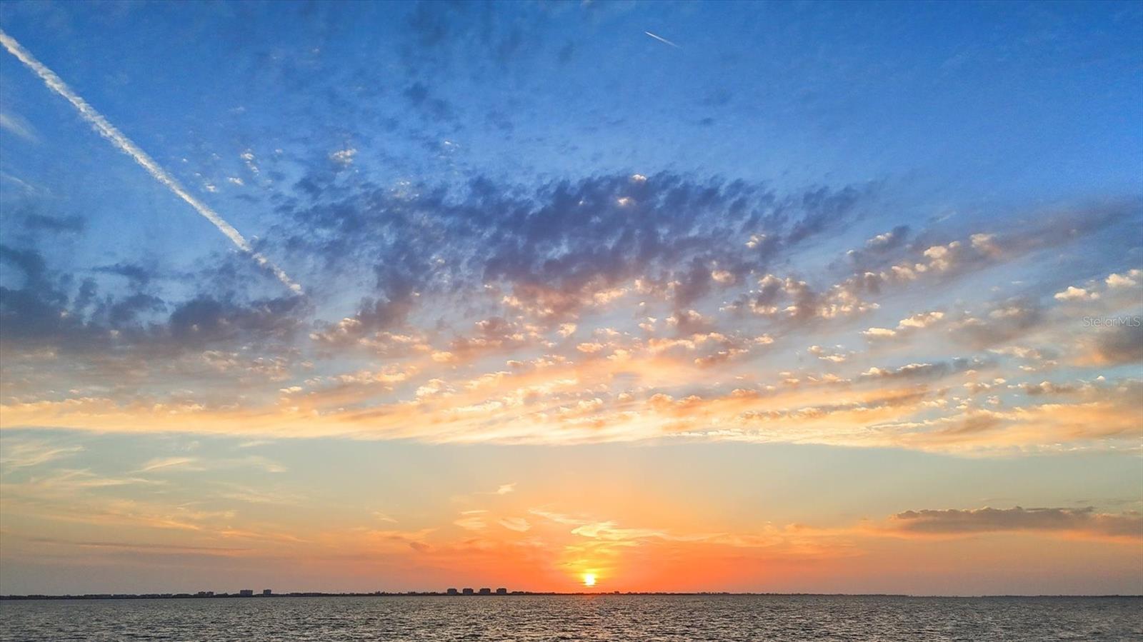 189 feet of rare boatable water frontage. Already cleared and elevated in preparation for a large contemporary estate, this nearly 1 acre lot offers generous buildable space and valuable privacy for your future vision. This extraordinary waterfront homesite offers some of the longest views to the West across Sarasota Bay and the Intracoastal Waterway. Significant estates, tree-lined streets and waterfront parks define this area. Coastal breezes always surround you; sunsets are, as you might imagine, spectacular. Driving down Indian Beach Lane provides a grand approach and beautiful introduction to this special location. Located in Indian Beach / Sapphire Shores - home to some of the finest historical architecture in all of Sarasota! And today, much like 100 years ago, it is being rediscovered by those with vision, appreciation and means. This coastal neighborhood has been a coveted location since around the time of its “founding” residents like the Ringling family and other prominent early Sarasotans. Water birds and peacocks are regular visitors here. Positioned perfectly between Sarasota-Bradenton International Airport (SRQ) and downtown Sarasota, yet still within short proximity to Longboat Key, St. Armands Circle and Lido Key. This particular location on Sarasota Bay also provides one of the most coveted features of all – boatable water to the site. Whether it’s a luxury yacht or something a bit more modest, access and dockage will be effortless. This homesite sits amongst other significant luxury homes – elegant coastal to the North, Mediterranean to the South with vintage and contemporary to the East. A site study including surveys and analysis is available, as are plans from one of the most renowned builders in the region. Or create your own masterpiece…your canvas awaits!