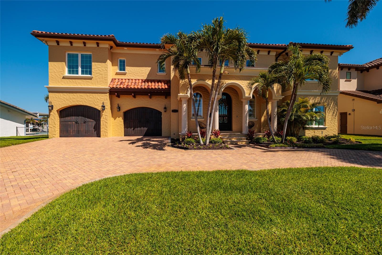 Palm Beach  Mediterranean Style in St. Pete! This home is for buyers who want a home with a SOUL! Built by respected builder John Wallace for his own family, this exceptional residence is a rare example of a waterfront home where you don’t just see the quality—YOU FEEL IT. (Bye Bye Builder Grade!) This is not TRENDING luxury... It's enduring LUXURY. From the moment you step inside, the home delivers a sense of solid, quiet, custom craftsmanship that sets it apart from today’s builder-grade new construction. Buyers consistently remark on the attention to detail—from the way the floors feel underfoot, to the fully trimmed windows, to the coffered ceilings that frame the soaring entry and hallways—creating a home that feels both luxurious and remarkably warm and livable.
A grand two-story entry with coffered ceilings, transom windows, wrought iron staircase, and rich custom millwork sets the tone, while solid core doors, crown molding, and built-ins throughout reflect true, enduring craftsmanship. The layout is intentionally designed to live beautifully, not just to impress. The ground floor offers expansive living space that flows directly to the pool, patio, and dock—perfect for everyday waterfront living and boating with two boat lifts (6,000 and 12,000 lb) and protected canal access to open Tampa Bay. This level also works exceptionally well for multi-generational living, featuring an elevator, two bedrooms, two full baths, a living room, and two separate bonus rooms.
Upstairs, the kitchen is truly the heart of the home, opening seamlessly to informal living and dining areas. The kitchen’s solid wood cabinetry provides a timeless, high-quality foundation and makes it easy to refresh the look with paint and countertops of your choice, if desired.
 The kitchen features a full Thermador appliance suite, a massive granite island with prep sink, wine cooler, pull-out storage, a separate counter with seating, a triple sink with pass-through to the living room, and a breakfast nook. Entertaining is effortless with a separate service kitchen and a formal dining room for special occasions. The second-floor living area opens to a balcony overlooking the water—perfect for relaxing, hosting, or enjoying the constant rhythm of boating life.
Beyond beauty, this home was built for serious peace of mind, featuring insulated concrete form (ICF) construction, reinforced pilings, a double sea wall, elevated lot, hurricane-impact windows and doors, hurricane-rated garage doors, flow-through garage vents, and a whole-house Generac generator. Additional features include an elevator, heated saltwater pool and spa, composite dock, reclaimed water irrigation, and an active Sentricon system.
Located in a walkable, social waterfront neighborhood, this is a home that defies expectations—timeless in its bones, easy to personalize cosmetically, and truly something you have to experience in person to appreciate. Ask your Realtor for the full list of features and safety details. Welcome home to Old-world architectural warmth with modern engineering!