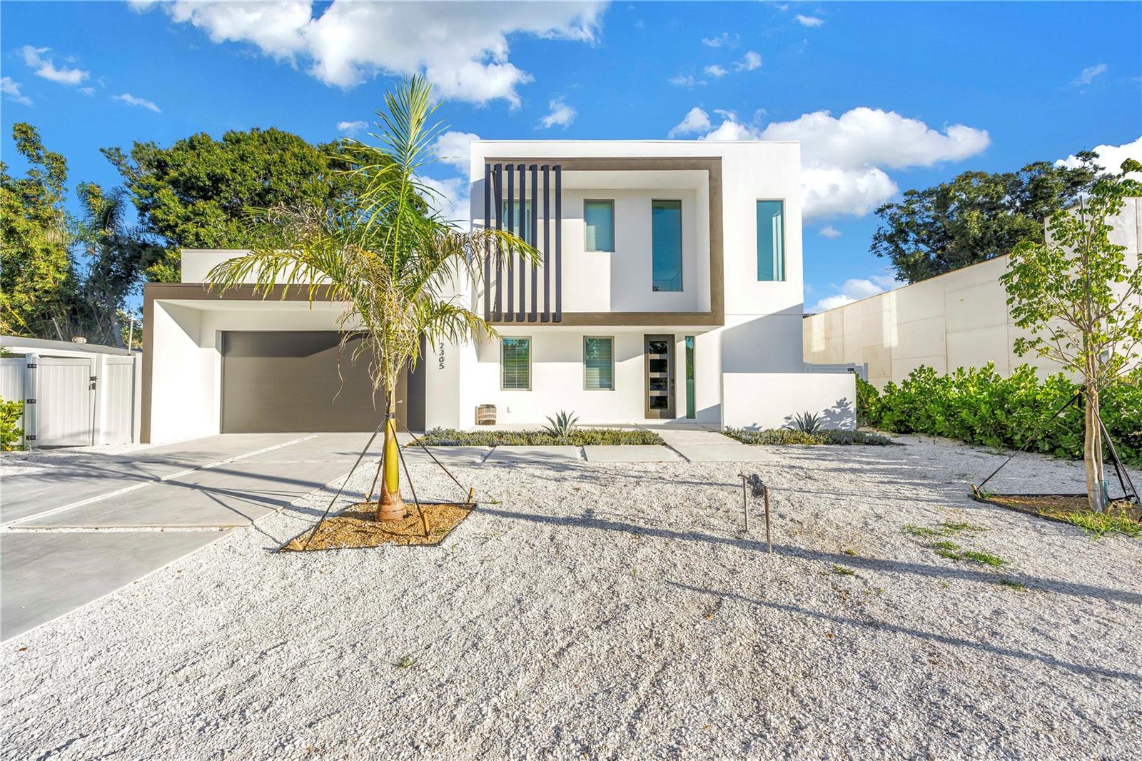 Tucked away on Temple Street, this stunning Sarasota home delivers the perfect mix of luxury, style, and comfort. With 5 bedrooms, 5 full baths, and 2 half baths (including a dedicated pool bath), every detail was designed for effortless living and entertaining.
Inside, bold black accents, designer lighting, and custom finishes set a sophisticated modern tone. The open layout flows seamlessly through the main living areas and a beautifully designed kitchen that’s as functional as it is striking.
Upstairs, a dedicated entertainment area with space for games and lounging offers the perfect hangout for family and guests. Step outside to your own private retreat featuring a heated pool and spa, outdoor shower, and a fully equipped outdoor kitchen ideal for dining and entertaining. Multiple balconies and shaded seating areas complete this exceptional property.
This home captures everything that defines modern Sarasota living—luxurious, inviting, and designed for unforgettable moments.
