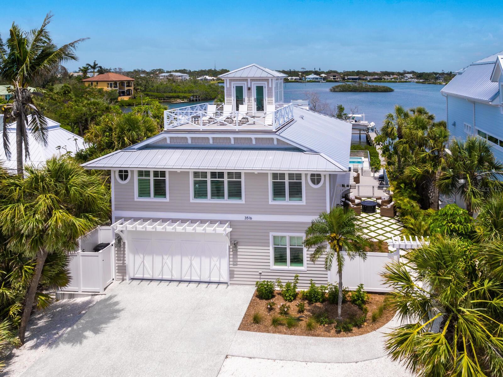 Casey Key Gulf-to-Bay | Private Beach | Curated Waterfront Residence.  
Welcome to this rare Gulf-to-Bay property on exclusive Casey Key, where timeless design meets modern coastal luxury. Reimagined and renovation completed in 2023— a new resort-style pool and spa added in 2025—this move-in-ready oasis offers private beach access, sweeping Intracoastal Waterway views, and a relaxed yet refined lifestyle.

Expansive open living spaces are filled with natural light and feature wide-plank wood flooring, exposed wood beams, and clean architectural lines. A working fireplace anchors the living room, connecting seamlessly to the great room and a chef-inspired kitchen.

The dual-concept kitchen is equipped with two Sub-Zero refrigerators, a Wolf range, two Asko dishwashers, and dramatic Zeus quartzite countertops. Custom cabinetry, designer lighting, and a spacious layout make it ideal for both everyday living and entertaining.

With four bedrooms, three and a half bathrooms, and a dedicated study/den, the floor plan offers flexibility and privacy. Upstairs guest suites enjoy spectacular water views from every room. An upper-level deck overlooking the Gulf is perfect for sunset viewing and quiet evening relaxation.

Built for coastal durability, the residence features hurricane-impact doors and windows, a standing seam metal roof, and cedar siding. Outdoors, the newly completed heated pool and spa, surrounded by lush tropical landscaping, create a private retreat. A 13,000 lb. boat lift and dock provide easy access to the Intracoastal for boating enthusiasts.

Casey Key is more than just an address—it's a lifestyle. This exclusive 8-mile island offers a rare blend of natural beauty, tranquility, and modern luxury. With pristine beaches, crystal-clear waters, and endless opportunities for water sports, it's a sanctuary for those seeking serenity and access to the vibrant culture of nearby Venice and downtown Sarasota.