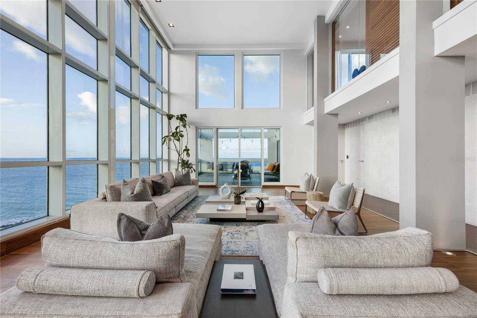 ***SOLD*** As featured on the cover of MODO DE VIDA, this extraordinary SPH soars above the only luxury high-rise directly on the sand of the famous Condado Beach - and the only building with panoramic, unobstructed ocean views. Step out your front door into a postcard Caribbean white sand beach for a morning swim in the turquoise waters then relax under the gently swaying palm trees of your new front yard. Enjoy the soothing ambience of the waves alongside spectacular sunrises and sunsets from your two spacious terraces while the refreshing ocean breeze keeps you cool year round. A masterpiece by world-renowned designer Gretchen Daubón, this light-infused 12th floor duplex with grand double height ceilings offers breathtaking ocean and skyline views from every corner of the expansive floor plan featuring a private elevator, 5 bedrooms, maid's quarters, 5.5 bathrooms, and 5,655 sq. ft of living space. The upper level features a grand primary suite encompassing the entire floor, inclusive of home office, double large walk-in closets, two bathrooms, boudoir and private terrace with full jacuzzi sitting above the water and oceanfront skyline. Located in the most desirable part of Condado with over forty hip, modern restaurants within ten minutes walk, Acquamarina at 1315 Ashford is a premium full-service building featuring a 24/7 doorman, heated swimming pool, kiddie pool, waterfalls, entertaining areas, jacuzzi, large gym, sauna, and steam room. Includes four storage units and four large garaged parking spots located by the gate for easy access. Three blocks from two of the best private schools in Puerto Rico. Monthly Maintenance: $1,853. Annual Hazard Insurance: $2,950. Discover the inspiration and intention behind the delicate design elements that adorn every inch of this home as celebrated on the cover feature of  Modo De Vida.