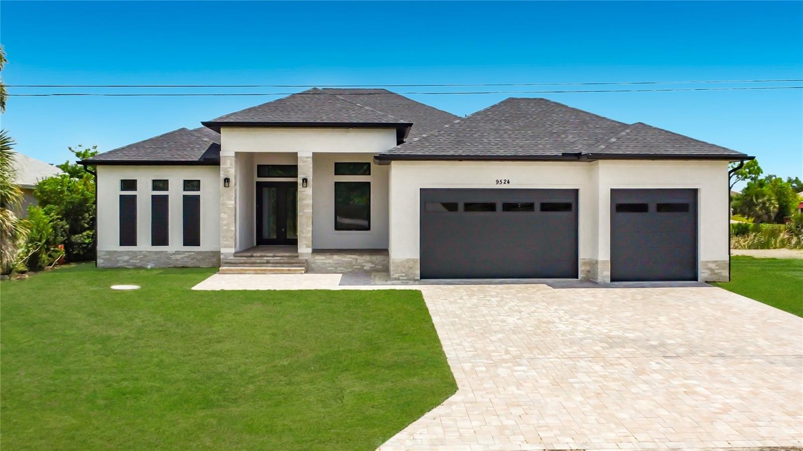 BRAND NEW WATERFRONT MASTERPIECE WITH GULF ACCESS. Welcome to 9524 Singer Circle, a stunning 2025 new construction residence located in the highly sought-after South Gulf Cove community. This modern architectural gem offers 2,162 sq. ft. of living space (3,607 total sq. ft.) featuring an open-concept layout with 3 bedrooms, 3 full bathrooms, and a dedicated home office.

No detail was spared: from the elegant stone accents and professional landscaping to the oversized 3-car garage (881 sq. ft.) and paver driveway. The chef-inspired kitchen flows seamlessly into the expansive Great Room, designed for high-end entertaining.

The "wow factor" continues outdoors: step into your private oasis featuring a massive screened-in lanai with a pristine pool, outdoor kitchen prep area, and breathtaking views of the saltwater canal. Boaters will appreciate the direct Gulf access and the serenity of sailboat water.

Located in a quiet circle near top-rated schools (Lemon Bay High) and with an optional HOA, this property represents the pinnacle of the Florida waterfront lifestyle. Schedule your showing today!