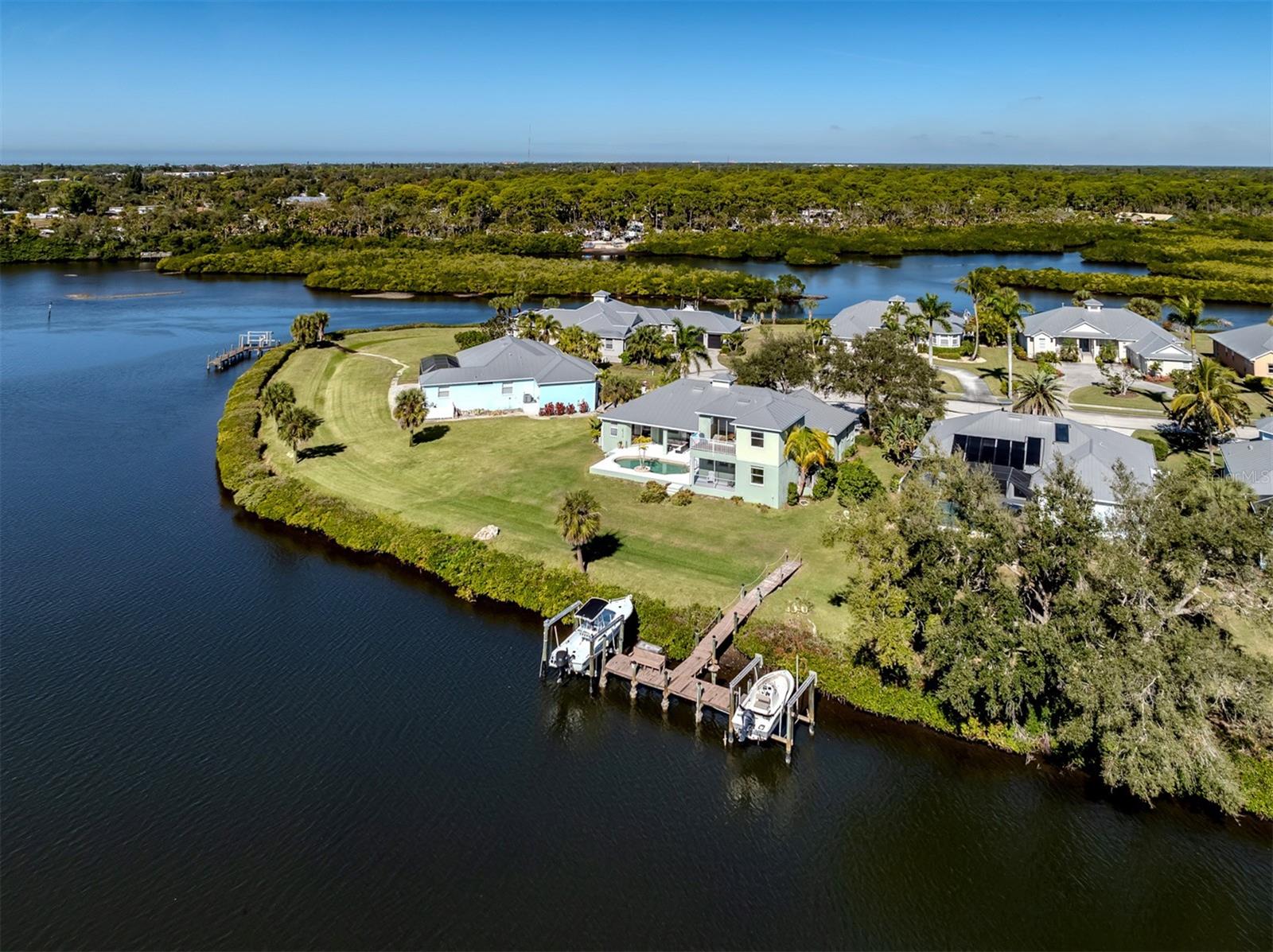 Positioned at end of a quiet cul-de-sac, this spacious split–floor plan home offers exceptional privacy on an almost half-acre lot with sweeping southwest-facing views of Shakett Creek on back of the entire home! In the exclusive gated community of Shakett Island, an intimate Key West-style enclave of just 22 homes, this residence offers a rare blend of charm, security and waterfront living with access to the tranquil Gulf. Spanning 3,602 square feet, the thoughtfully designed home features four bedrooms, two full baths, two half baths, a three-car oversized garage, private pool, and a shared dock with a 12,000-pound boat lift ideal for boating enthusiasts and sunset lovers alike. The interior is elegant and inviting, beginning with formal living and dining rooms, each offering sliding glass door access to the expansive lanai for seamless indoor-outdoor living. The spacious kitchen serves as heart of the home and is equipped with stainless appliances, center island, breakfast bar, walk-in pantry, additional storage pantry, and a dinette framed by an aquarium window overlooking the pool and water. The kitchen opens effortlessly to a bright great room highlighted by expansive windows, stunning water views and direct lanai access. The oversized primary suite is a private retreat featuring private lanai access, expansive walk-in closet, and spa-inspired en suite with dual vanities, private water closet, walk-in shower and Jacuzzi tub. A discreet private door connects the primary suite to the fourth bedroom used as an office, offering flexibility as a nursery, craft room or guest space. Just off the great room, a pocket door reveals bedrooms two and three, a well-appointed full bath and under-stair storage. Upstairs, a spacious bonus room features additional storage closets, a powder room, large windows, and access to a private deck overlooking the pool and long water views of Shakett Creek, ideal for guests, a media room or a peaceful retreat. The split three-car garage is designed for function and storage, offering dual garage doors, an extended single bay, side exterior access and abundant storage throughout the home. The expansive open lanai showcases breathtaking water views, undercover seating, ample space for dining and lounging, and convenient access to a pool bath. With direct water access (fixed bridges to the Gulf), spectacular sunsets, abundant storage and a one-of-a-kind island setting, this home represents the best of coastal Florida living. Conveniently near Sarasota Memorial Hospital, A-rated schools, pristine Gulf beaches, downtown Venice, Wellen Park, CoolToday Park (Braves spring training), shopping, dining, Interstate 75 and U.S. 41.