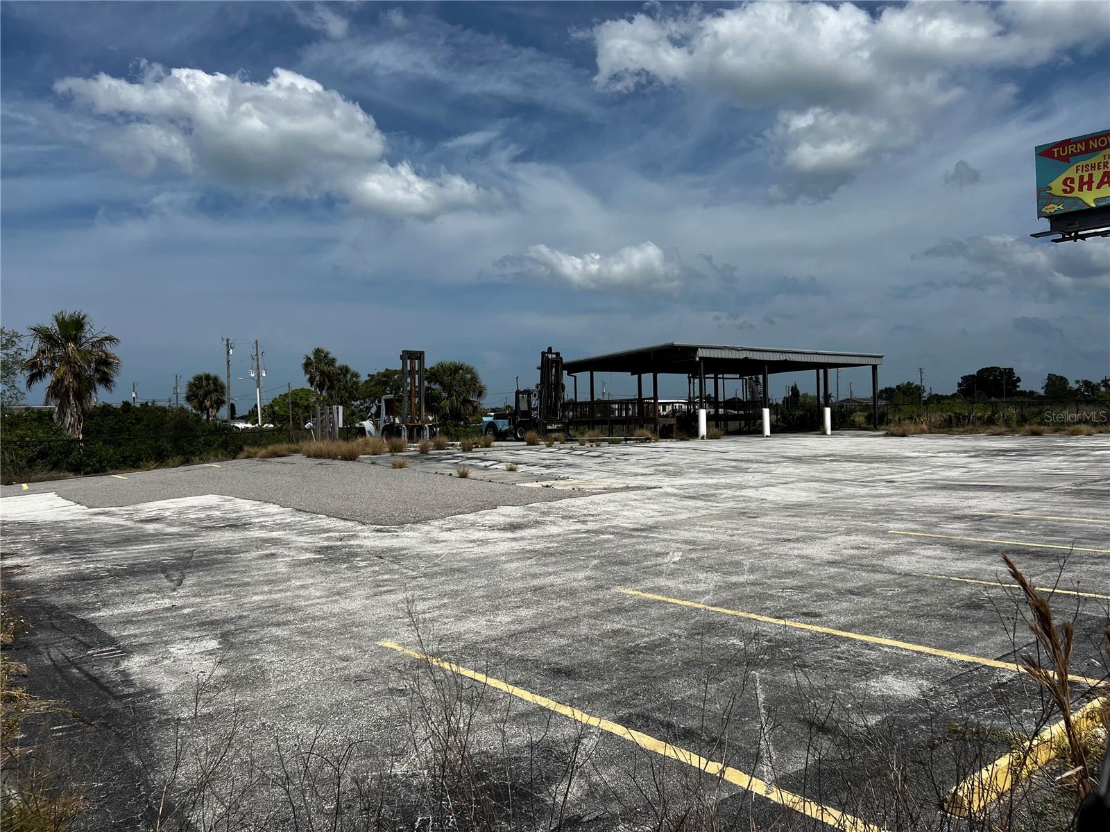 1.38 acres on US 19 and Puffin Lane in Hudson Florida, chain link fenced with a 2244' covered area with concrete floor, paved parking lot. Zoned C2.
