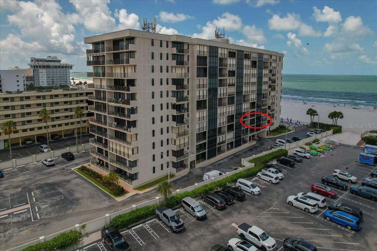 Welcome to Seamark, one of St. Pete Beach's premier gated beachfront communities. This beautiful fully furnished 2-bedroom, 2-bath condominium offers the perfect combination of comfort, style, and resort-style living. Natural light pours into the spacious main living area through dramatic floor-to-ceiling windows, accented by plantation shutters that provide both character and privacy. The updated kitchen features neutral wood cabinetry, granite countertops, a coordinating backsplash, and stainless steel appliances. Open to the spacious dining area, the layout creates a seamless flow for everyday living and entertaining. The thoughtfully designed floor plan includes two private balconies, one attached to each bedroom, with convenient access from the living room, allowing you to enjoy outdoor living and coastal breezes from multiple areas of the home. The primary suite offers a private bath, while the guest bedroom provides comfortable accommodations for family and visitors. Residents of Seamark enjoy an exceptional collection of amenities, including a heated beachfront swimming pool, fitness center, clubhouse, and direct access to the white sandy beaches of the Gulf of Mexico. Beautifully maintained grounds and a secure gated entrance complete this desirable community. Ideally located near amazing restaurants, shopping, entertainment, and everything St. Pete Beach has to offer, this turnkey residence is perfect as a full-time home, seasonal retreat, or vacation getaway.