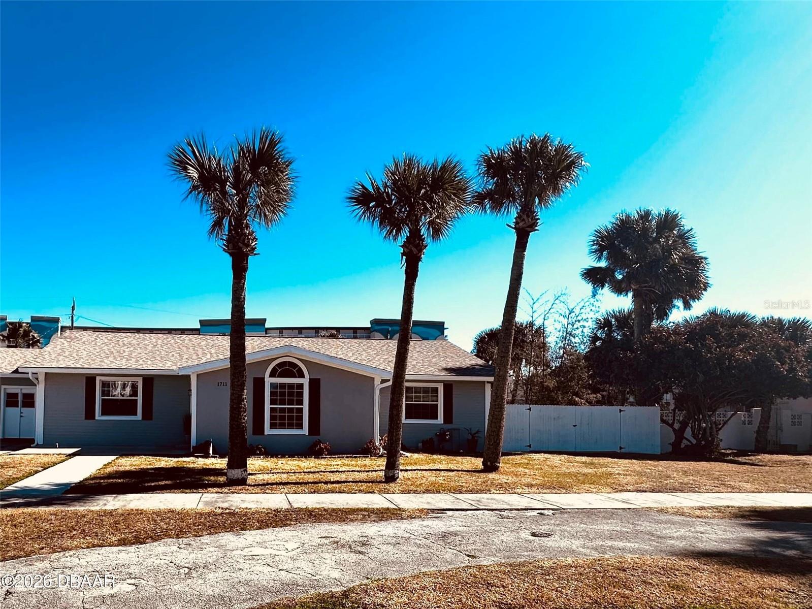 BEACH LIFE AT ITS FINEST! Located in the desirable Ocean Dunes community just one block from the World's Most Famous Daytona Beach, this spacious 5-bedroom, 2-newly remodeled baths offers open-concept living with beautiful wood floors throughout. The updated kitchen features stainless appliances, granite countertops, raised-panel cabinetry, and an oversized island perfect for entertaining. Built-in utility area and flexible layout with in-law suite potential. Situated on an oversized lot with gated boat/RV parking and 30-amp RV hookup. Enjoy updated bathrooms, newer roof and A/C, natural gas service with on-demand hot water, and excellent energy efficiency for low monthly costs. Just steps to both the beach and Intracoastal—perfect for true coastal living!