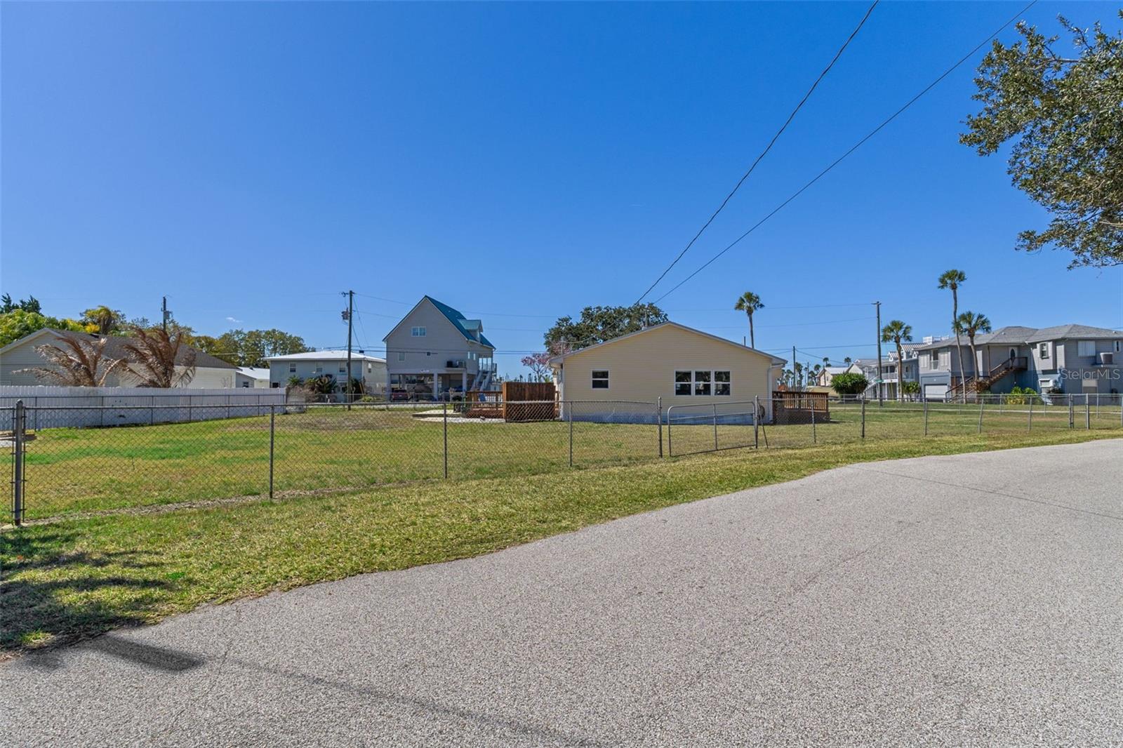 Unique vacant land opportunity with beautiful water views in an exceptional location—just moments from the crystal-clear main river and Rogers Park. Situated on the west side of the bridge along the Weeki Wachee River, this nearly half-acre property offers ample space for all your water toys, including boats, RVs, jet skis, and more. Adding to its value, the property includes a bonus 2-bedroom, 1-bath home—ideal for use as a guest house, rental opportunity, or temporary residence while you build your dream home. Whether you're searching for a full-time residence, weekend retreat, or investment property, this offering provides exceptional flexibility in one of the area's most sought-after waterfront locations. The property is fully fenced, offering both privacy and convenience.