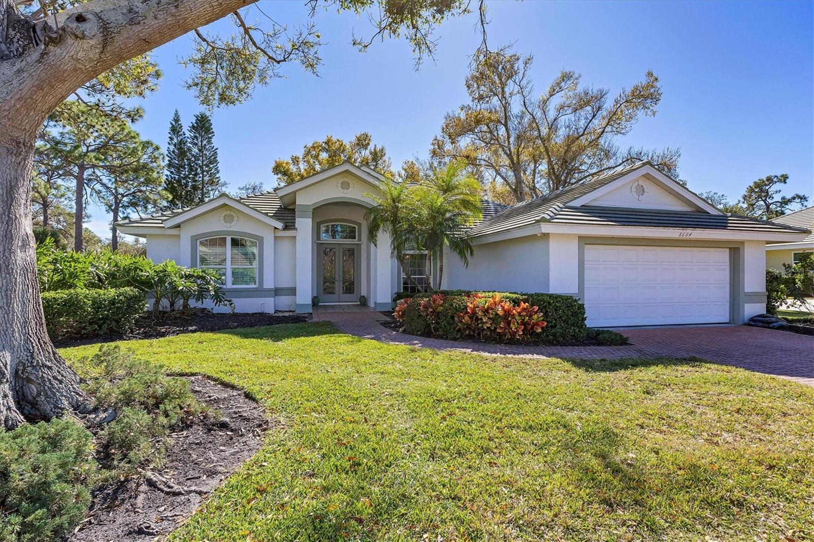 Nestled within a gated community, this Lee Wetherington custom-built home offers a rare blend of privacy and comfort with all hurricane impact windows, refinished pool and private backyard. From the moment you enter the community, you'll appreciate the sense of tranquility and security that defines this neighborhood. The home features three bedrooms, one of them currently set up as an office, two full bathrooms, and one-half bath, thoughtfully arranged to provide both functionality and comfort. Natural light fills the living spaces, enhancing the warm and inviting layout that is ideal for everyday living as well as entertaining guests. The well-designed floor plan allows for seamless flow between living, dining, and gathering areas, creating a space that feels open yet cozy. Step outside to your own private backyard retreat, where a sparkling private pool is surrounded by mature greenery, offering exceptional privacy. Located within a gated community, residents enjoy an added level of security and exclusivity, along with a well-maintained environment that reflects pride of ownership. Roof was replaced in 2016, HVAC and water heater 2019, pool heater 2025, windows 2018-2020 and pool was resurfaced in 2022.  In addition, Costco, YMCA, Legacy Trail and Siesta Key are only short drive away.