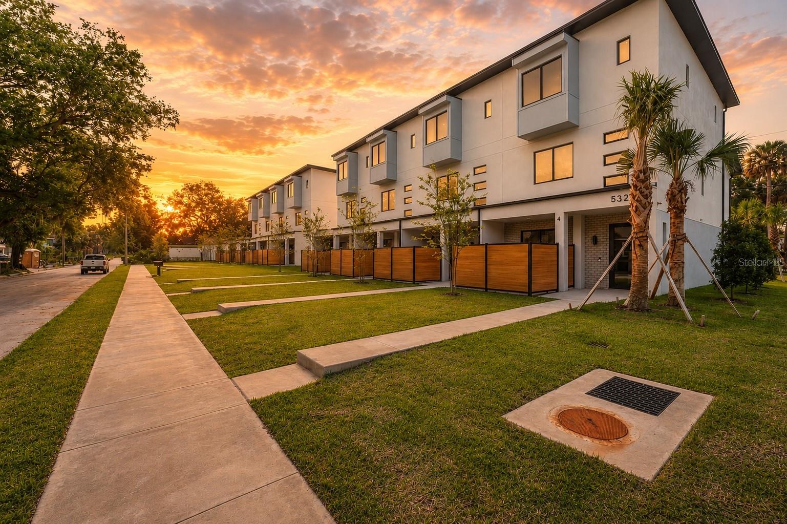 Virtually Staged. Experience elevated urban living in this modern luxury Tampa townhome just minutes from Armature Works, Downtown Tampa, and the Riverwalk. Designed for both style and function, this modern residence features premium finishes, smart design elements, and expansive indoor-outdoor living spaces in one of Tampa’s most desirable neighborhoods. Property highlights include: • Private dumbwaiter connecting the garage to kitchen (with 300 lb carrying capacity) • Oversized 24-foot-deep garage ideal for large SUVs, trucks, and additional storage • Spacious bedrooms with private ensuite bathrooms and walk-in closets • Designer chef’s kitchen featuring a 13-foot waterfall island, wine and beverage refrigerator, exterior-vented range hood, built-in trash cabinet, and direct dumbwaiter access • Two private outdoor living areas including a fenced first-floor patio and screened second-floor balcony with low-maintenance composite decking • Engineered hardwood flooring throughout with matching hardwood stair treads for a seamless upscale finish • Premium construction upgrades including Level 4 drywall finish, insulated interior walls for enhanced privacy, oversized 8-foot doors, and solid wood interior doors. Windows and doors are large missile impact rated. The exterior is professionally maintained with community irrigation, integrated drainage systems, and gutters routed directly into the city sewer system underground to minimize standing water and improve long-term functionality. Located in the heart of Tampa Heights, this move-in-ready luxury townhome offers the perfect balance of modern convenience, sophisticated design, and walkable city living near Tampa’s top restaurants, nightlife, and entertainment destinations.