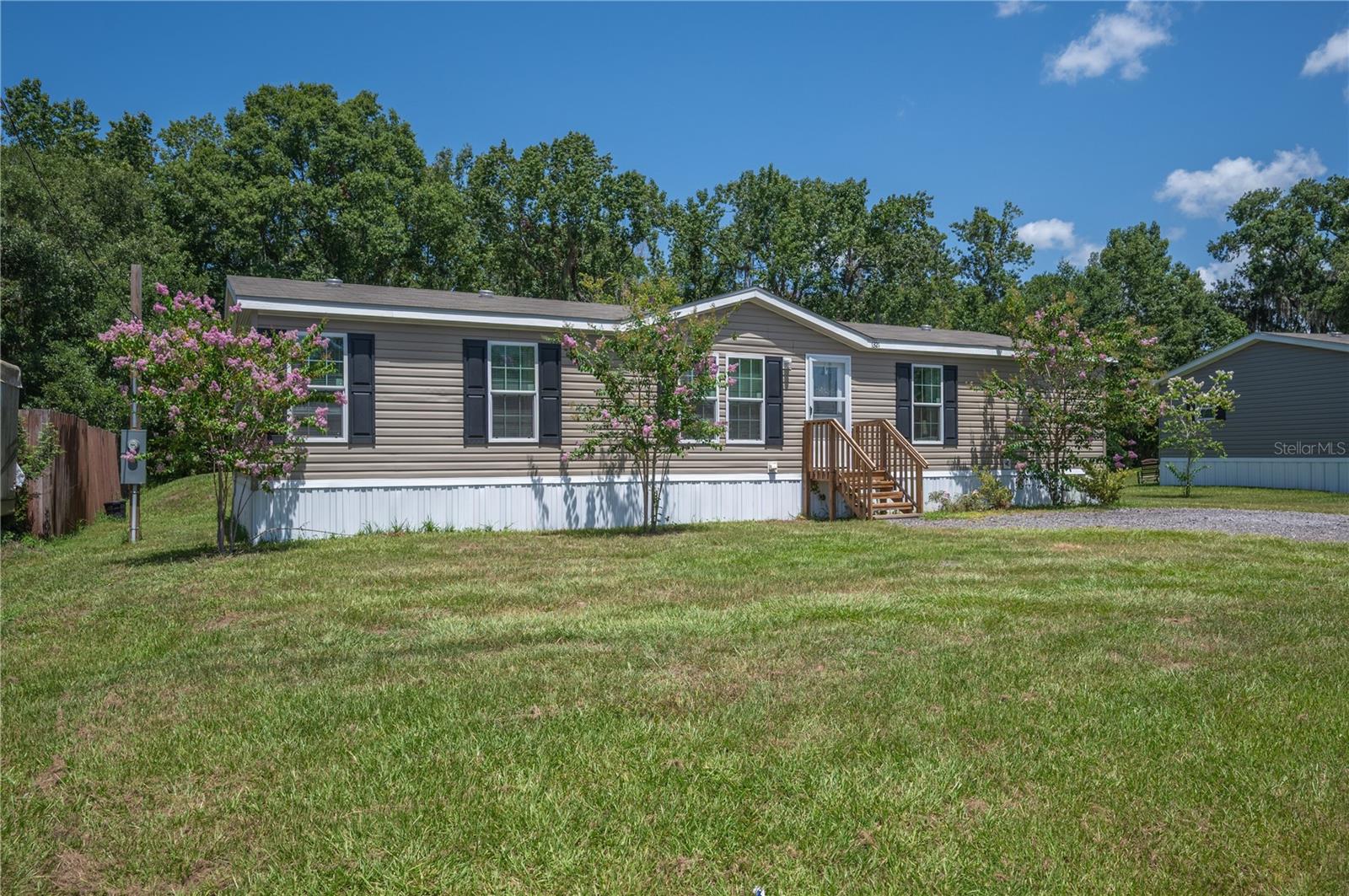 Welcome home to this beautiful 2024 manufactured home located in desirable South Lakeland! Offering 4 spacious bedrooms and 2 full bathrooms, this thoughtfully designed split floor plan provides both comfort and privacy for the whole family. The heart of the home features a bright eat-in kitchen with plenty of space for gathering and everyday living. The open layout creates a welcoming atmosphere, perfect for entertaining or relaxing at home. Situated on a generous 0.67-acre lot, you'll enjoy the peace and privacy of a wooded backyard with no rear neighbors, creating the perfect setting for outdoor activities, gardening, or simply unwinding. A storage shed provides additional space for tools, lawn equipment, or hobbies. If you're looking for modern construction, room to spread out, and a private setting in South Lakeland, this property is one you won't want to miss. Schedule your private showing today!