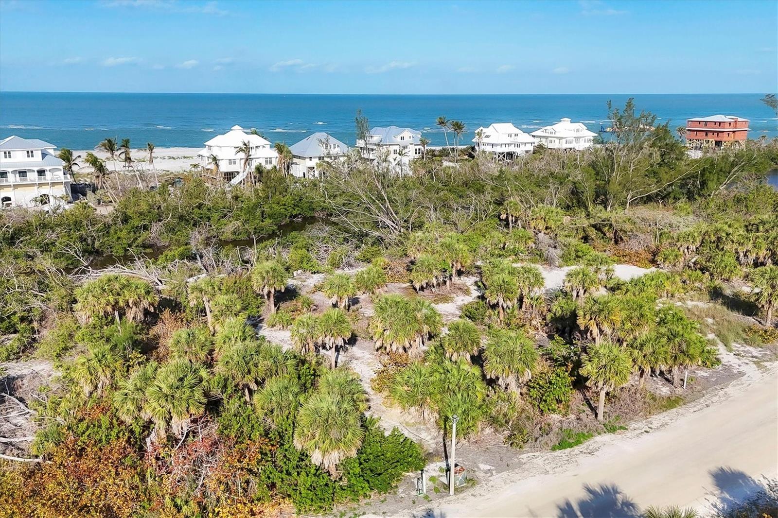 PRICE CHANGE! UNIQUE OPPORTUNITY TO BUILD YOUR DREAM HOME on over a half acre lot located inside the gated community of Sabal Palm Point, but located on Rum Cove. This lot is located on a private island that may be reached by boat, or a 4 minute car ferry ride, where you would drive to Palm Island Resort, and take a golf cart from there to your property. You may make an investment into the resort to use their amenities, such as bellman, use of the parking lot, resort patrol. You have granted access to the Gulf of Mexico beaches. This property  also backs up to Hidden Lake, a great place to kayak or SUP. The intracoastal side of Sabal Palm Point has newly built community docks that are great for fishing off of as well as tying up your boat, or launching your kayak. The electronic gate gives you extra privacy and security. It is shared with the small Rum Cove community. The pristine beaches are within a 1/4 mile walking distance, or a quick ride on a golf cart. You have up 7 miles of beach to walk and explore. Come build your dream home in paradise!