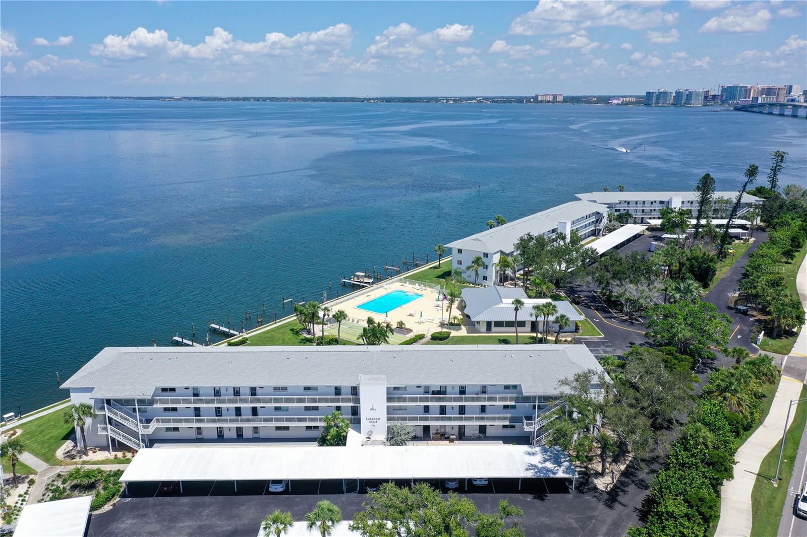 Direct Waterfront, newly updated 2 bedroom 2 bath end unit with hurricane resistant windows and sliders.  Sarasota Harbor East, a premier 55+ maintenance-free community in one of the most desirable bayfront locations in Sarasota! Just minutes from downtown Sarasota, St. Armands Circle, Lido Beach, and directly across from the Sarasota Yacht Club, this community offers an unmatched combination of convenience, charm, and waterfront living.  This residence features a fully glass-enclosed lanai—perfect for soaking in the spectacular waterfront views. The unit also comes with a covered parking space plus ample guest parking.  Community highlights include: Free boat docks for sailboats or powerboats up to 30’ (first-come, first-serve), heated waterfront pool with stunning bay views, community gas grill and picnic area, secured covered bicycle shed & kayak storage, individual storage bins for residents.  With its unbeatable location, Sarasota Harbor East is a rare opportunity to own in one of Sarasota’s most sought-after waterfront communities.