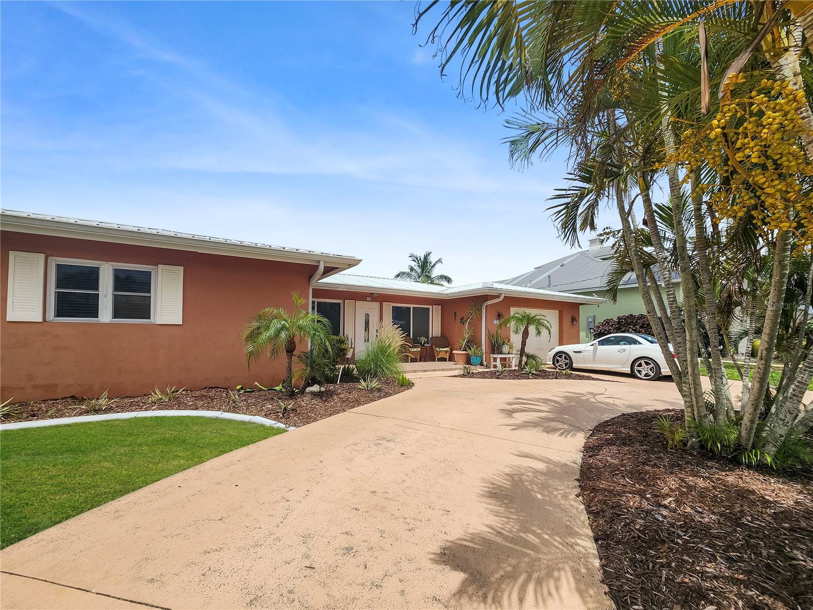 Experience the best of Punta Gorda Isles waterfront living in this beautifully updated 3-bedroom, 2-bath home offering 80 feet of waterfront, stunning intersecting canal views, and approximately 10-minute powerboat access to Charlotte Harbor and the Gulf of Mexico. Perfectly positioned on Sailfish Estuary, this property delivers the boating, fishing, and Florida lifestyle buyers dream about.

The exterior is designed for waterfront enjoyment with a concrete seawall, private dock, boat lift, large screened lanai, lush tropical landscaping, and two fenced outdoor areas ideal for pets, gardening, or private outdoor relaxation. Whether you're heading out for a day on the water or enjoying the peaceful canal views from home, this property makes it easy to enjoy Southwest Florida year-round.

Inside, the bright and spacious floor plan features tile flooring throughout, crown molding, abundant natural light, and multiple living and entertaining areas. The updated kitchen is the centerpiece of the home, showcasing granite countertops, custom wood cabinetry, and premium stainless-steel appliances including a Bosch range, GE Monogram refrigerator and hood, Fisher & Paykel double-drawer dishwasher, and GE Profile microwave. A breakfast bar pass-through opens to a versatile bonus room that can serve as a family room, dining area, or additional living space.

The primary suite offers a custom California walk-in closet, private bath, and direct access to a fenced side yard, creating a peaceful retreat. A split-bedroom floor plan provides privacy for guests, while the additional bedrooms offer generous space and custom closet storage.

Additional features include impact windows, a metal roof, circular driveway, air-conditioned garage, and a newer air-conditioning system. This well-maintained home is move-in ready and offers exceptional value for buyers seeking waterfront living without compromise.

Located in one of Southwest Florida's most desirable boating communities, residents enjoy easy access to the Punta Gorda Isles Yacht Club, Fishermen's Village, historic downtown Punta Gorda, waterfront parks, golf courses, shopping, dining, entertainment, community events, I-75, and Gulf beaches.

Whether you're searching for a year-round residence, seasonal retreat, or waterfront investment, this exceptional property offers the location, boating access, and lifestyle that make Punta Gorda Isles one of Florida's most sought-after destinations.