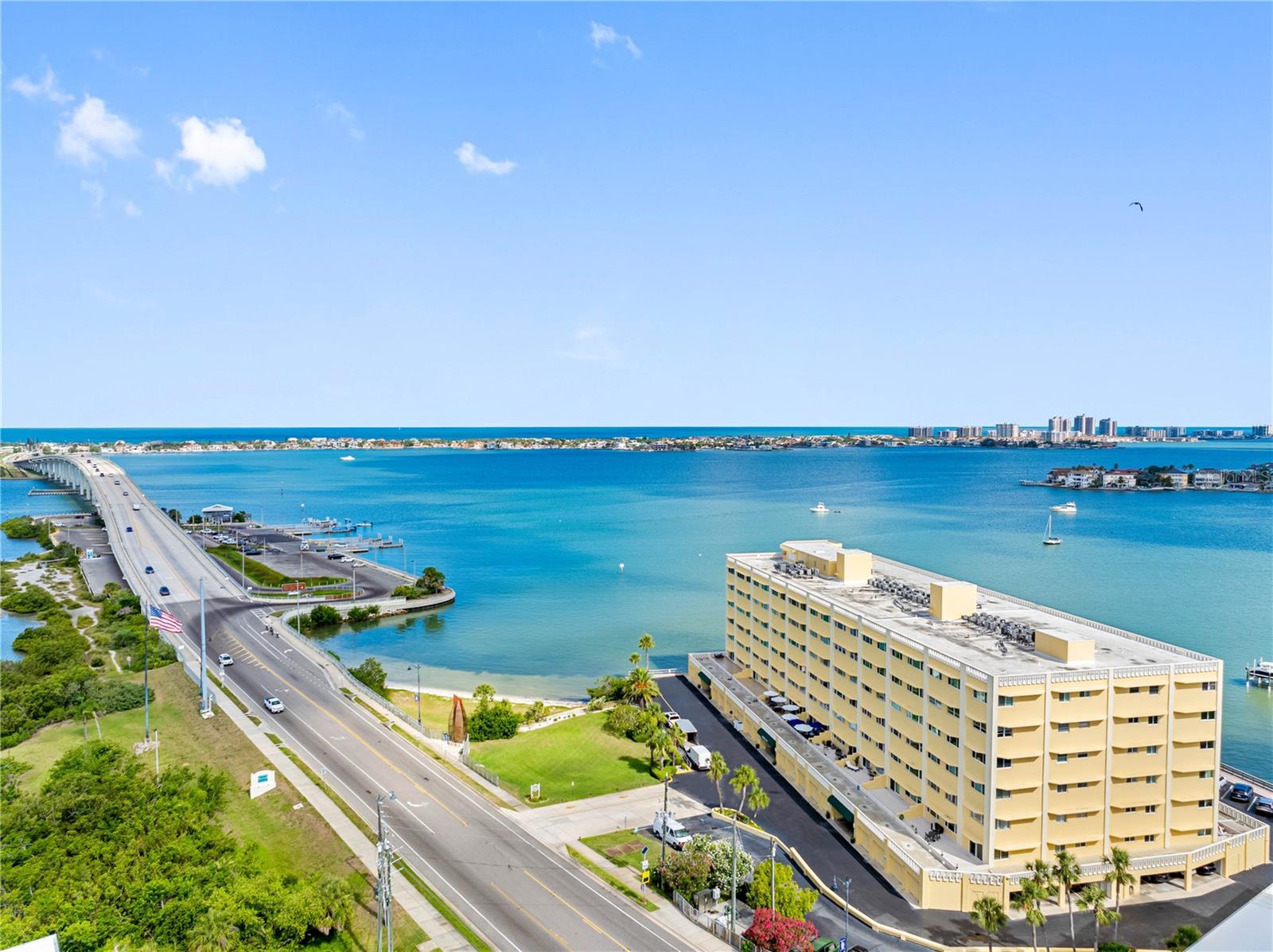 One or more photo(s) has been virtually staged. **NEW LOWER PRICE, Spectacular Views Included** Discover the ultimate Florida waterfront lifestyle in this gorgeous Belleair Bluffs condo, perfectly positioned in the sought-after Harbour Club C building that welcomes residents of ALL AGES. This light-filled, refreshed home showcases a roomy split floor plan and impressive north-facing windows that deliver spectacular views of the intracoastal waterway and harbor. The condo has been recently updated with brand new soft-close kitchen cabinets, Frigidaire stainless steel appliances, sleek quartz countertops, stylish bathroom vanities, modern tile surrounds for both tub and shower, updated plumbing and lighting fixtures, new ceiling fans, luxury vinyl flooring, and fresh paint throughout creating a contemporary and welcoming ambiance.
The spacious primary suite features a walk-in closet, private bathroom with a tiled walk-in shower, quartz counters and dual sinks. The comfortable guest bedroom provides peaceful water views from the bedside area and includes its own walk-in closet, while a versatile bonus room is ideal for a home office, cozy reading spot, or den complete with expansive panoramic views. Enjoy the convenience of an in-unit laundry room, equipped with new full-size Samsung washer and dryer units.
The thoughtfully designed kitchen offers plentiful cabinet storage and generous counter space, making it perfect for preparing meals or hosting guests. There is a dedicated spot for a coffee bar as well as counter seating for casual dining.
Step outside to unwind by the community pool, play a game of shuffleboard with friends, or enjoy fishing from the nearby dock. This condo is conveniently located just a short drive from Belleair and Indian Rocks Beach, where you’ll find lively restaurants, shopping, grocery stores, and stunning sandy beaches along the warm Gulf waters. The reasonable monthly HOA fee includes Cable TV and Internet, as well as water, sewer and trash. This condo also includes one reserved parking space under the building and a storage closet for your bikes, beach and other outdoor gear. Take advantage of the opportunity to live in a place where comfort, convenience, and breathtaking views blend seamlessly, and offered at an attractive price. Start living the Florida life today!