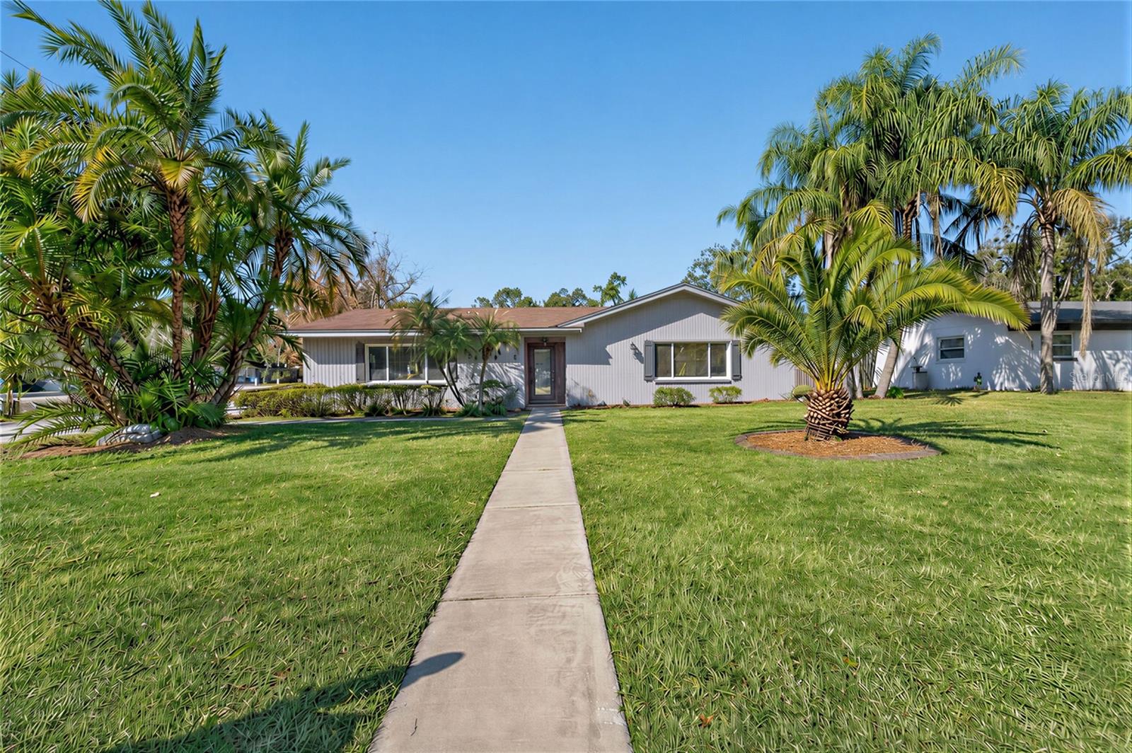 Virtually Staged. LOCATION LOCATION LOCATION AND NO HOA Repeat NO HOA - 4 Bed 3 Bath POOL home with Mother-in-law suite 3 blocks from  LAKE HOLLINGSWORTH with is own white picket fence. Home has 4 bedrooms, 3 living areas, 3 full baths. New Carpet in 3 of the 4 bedrooms. New Paint on interior and pool deck.  The converted garage provides incredible bonus living space ideal for mother in law suite, a game room, gym, media room, playroom, home office, or additional family area.  • Roof (2016) • Whole-house replumb (2019) • A/C (2020) • Luxury Vinyl Plank Flooring (2022) • Upgraded Water Heater (2025) minutes from downtown Lakeland, lakes, parks, top schools, shopping, dining, and medical facilities. Second living room has French doors that open directly to the screened in pool area, with covered patio and TV connections for outdoor entertaining. Third full bathroom can be accessed from the pool deck. Long driveway offers area that could be converted to carport with after market options. Easily park 6 cars on the driveway for  Short Term Rental Investors dream near Colleges and downtown enjoyment. CALL QUICK BEFORE THIS ONE IS GONE!!