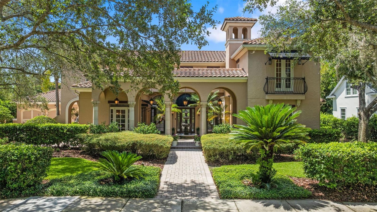 Introducing 102 Acadia — the one you’ve been waiting for. A rare gem nestled on what may be the most coveted lot in all of Celebration, this serene lakeside estate blends the beauty of nature with timeless Mediterranean-inspired architecture. Set back from the street amid lush, mature landscaping, the home offers a sense of peace and privacy while placing you moments from Celebration’s charming town center, scenic trails, golf, tennis, and community events. From the moment you step through the front door, you’re greeted by sweeping lake and preserve views that set the tone for a home designed to connect indoor living with the natural beauty that surrounds it. The light-filled great room flows effortlessly to the lanai, pool, and palms beyond — each space bathed in Florida sunshine and oriented for spectacular sunsets. At the heart of the home, a chef’s kitchen pairs rustic character with modern performance. Custom cabinetry crafted from 100-year-old barnwood provides warmth and authenticity, while state-of-the-art appliances — including a 48" Wolf dual oven range with six burners and griddle, Fisher & Paykel column refrigerator and freezer, dual dishwashers, microwave drawer, and beverage bar with wine rack — cater to the most discerning cook. A large island and adjoining dining room make this space ideal for hosting gatherings both large and intimate. The first-floor primary suite is a retreat of generous proportions, featuring a large walk-in closet and a luxurious ensuite bath with dual vanities, soaking tub, and walk-in shower. Each of the home’s six bedrooms — two on the main level and four upstairs — has been thoughtfully designed as a private retreat, blending space, light, and comfort. Outdoors, living and dining areas invite you to lounge, entertain, or simply savor the view. A large lakeside pool serves as the centerpiece, flanked by a fire pit for evening gatherings. South-facing exposure means warm, sun-filled days and magical sunsets, while manicured hedges, butterfly-attracting gardens, and mature palms create a private, tropical sanctuary. Additional amenities include a three-car garage, integrated speaker system, solar panels, tankless water heaters, central vacuum, and security system. With its combination of rare location, graceful architecture, and thoughtful upgrades, 102 Acadia is more than a home — it’s a private paradise in the heart of one of Florida’s most beloved communities.