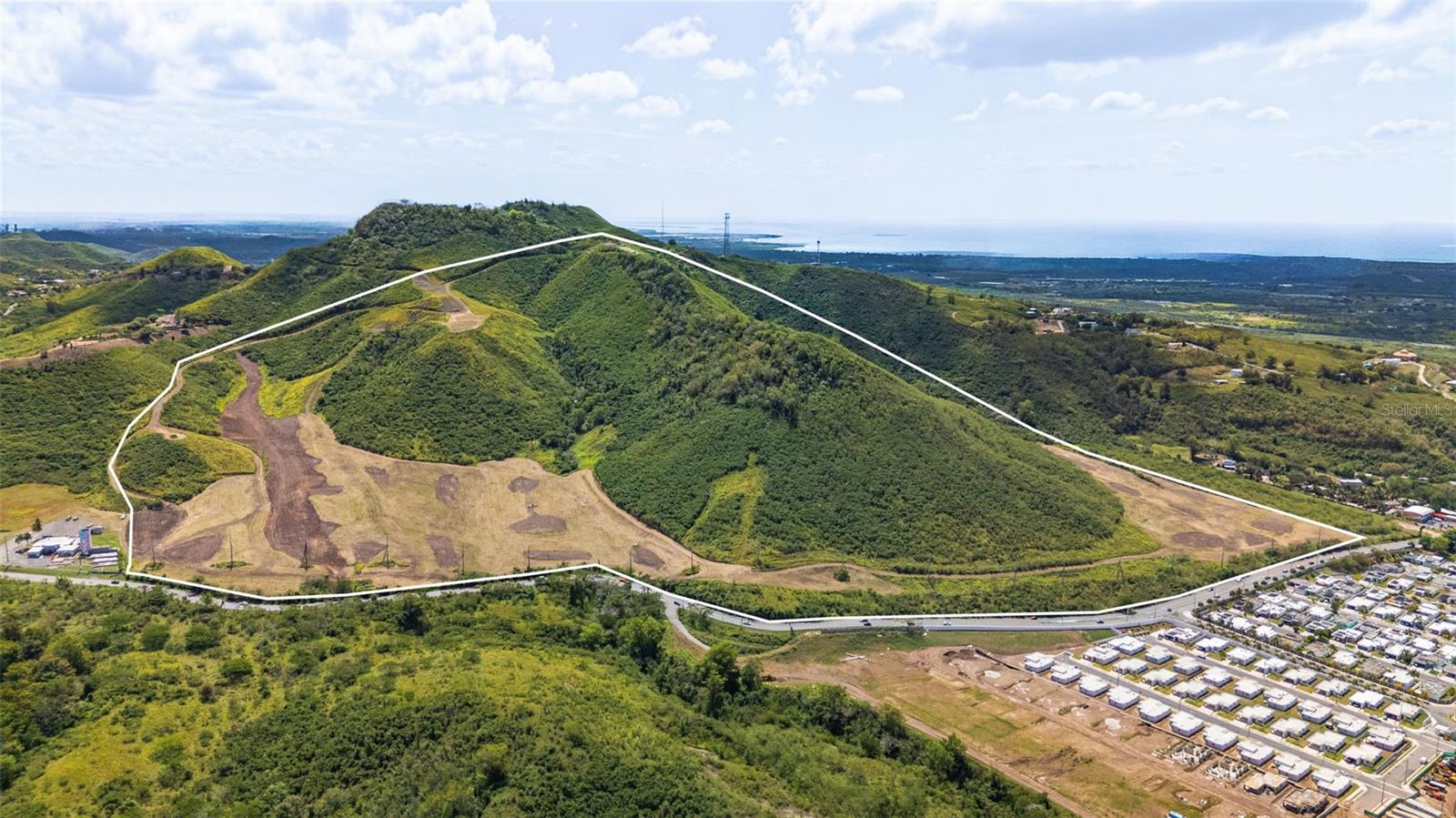 Positioned in Santa Isabel, this 141-cuerda development site brings together scale, infrastructure readiness, and a defined residential vision oriented around coastal living, supported by open Caribbean Sea views and immediate connectivity to one of Puerto Rico’s principal transportation corridors. This is a rare opportunity to acquire the equivalent of 139 acres of shovel-ready land with plans for a mixed-use residential community. 

The design contemplates a well-balanced development program including condominium-style residential buildings, single-family homes, land lots for custom residences and a designated commercial component. This framework supports a flexible development strategy with the ability to phase construction, diversify product offerings, and align delivery with market demand while maintaining overall community cohesion. 

On the ground, the site is already organized for progression into construction. Primary internal pathways have been cleared and defined, establishing an efficient circulation layout that transitions seamlessly into paving and full infrastructure build-out. The scale and topography support streamlined implementation across multiple phases without compromising design intent or planning integrity. Strategic enhancements further elevate the scope of the project, aligning the development with high-access mobility considerations for future residents and stakeholders. 

Connectivity remains highly efficient: the site is approximately 10 minutes from PR-52, ensuring direct linkage to the island’s principal highway network, and about one hour from San Juan, maintaining a practical connection to the metropolitan core while preserving a distinct coastal setting. 

This is a fully structured residential development platform designed for execution efficiency, program flexibility, and long-term value creation at scale.