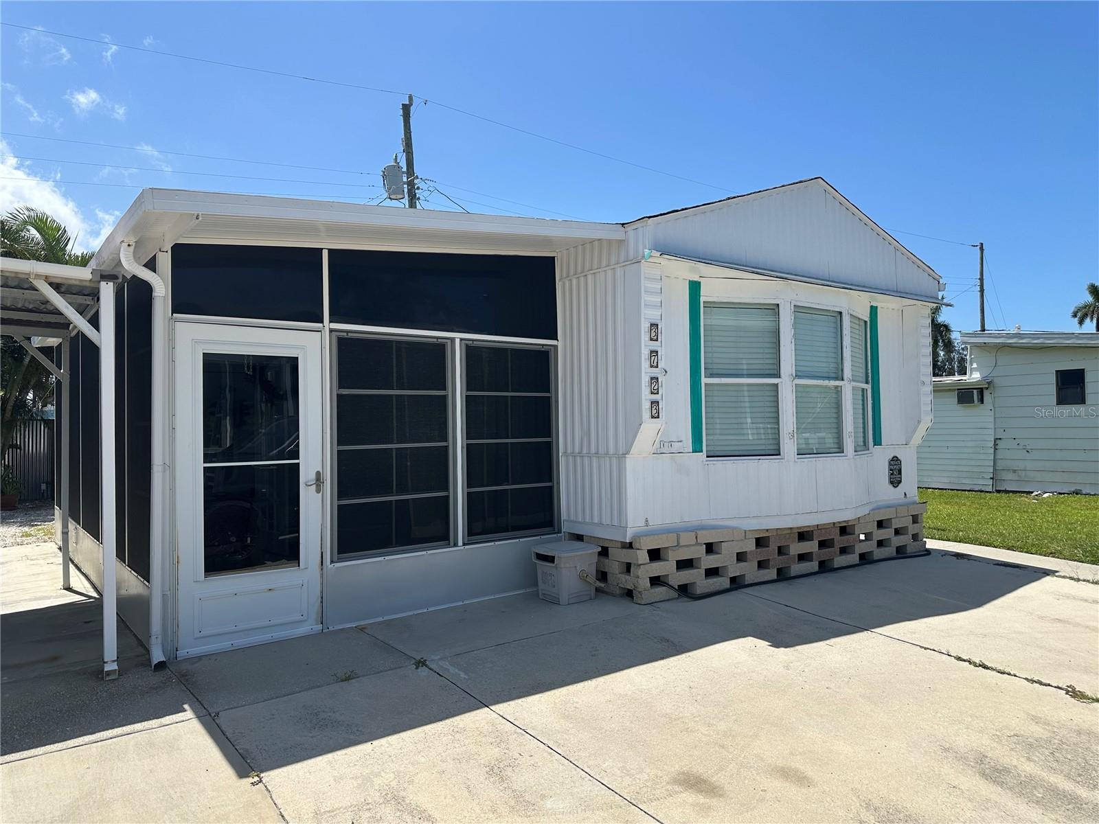 TWO miles from the beautiful sandy beaches. Walk, ride your bike, or take a golf cart to beautiful Anna Maria Island and enjoy the island lifestyle without the island price tag. This affordable property offers a fantastic opportunity as a primary residence, vacation home, or income-producing investment. With the potential to generate short-term rental income, it could help pay for itself. The neighboring property is also available for sale, creating a unique opportunity to live in one home and rent the other. One of the best features of this property is that you own both the home and the land, meaning there is no lot rent. There are no HOA or association fees, although an optional annual clubhouse membership is available. Access to community boat ramp too! Property taxes and utility costs are low, helping keep ownership affordable. The home is conveniently located just a couple of blocks from Palma Sola Bay and the county park, making it easy to enjoy boating, fishing, kayaking, walking trails, and spectacular sunsets. The home features two bedrooms and one bathroom with a walk-in shower. A spacious enclosed lanai with two separate entrances provides additional living space, while the second bedroom includes a generous 8-by-6-foot walk-in closet. Parking is available directly in front of the home for added convenience. Outside, you'll find two storage sheds, an outdoor beach shower, a covered BBQ area, and a sunny deck perfect for relaxing and enjoying Florida's beautiful weather. This charming property offers an affordable way to experience the laid-back coastal lifestyle while enjoying the benefits of homeownership and investment potential.