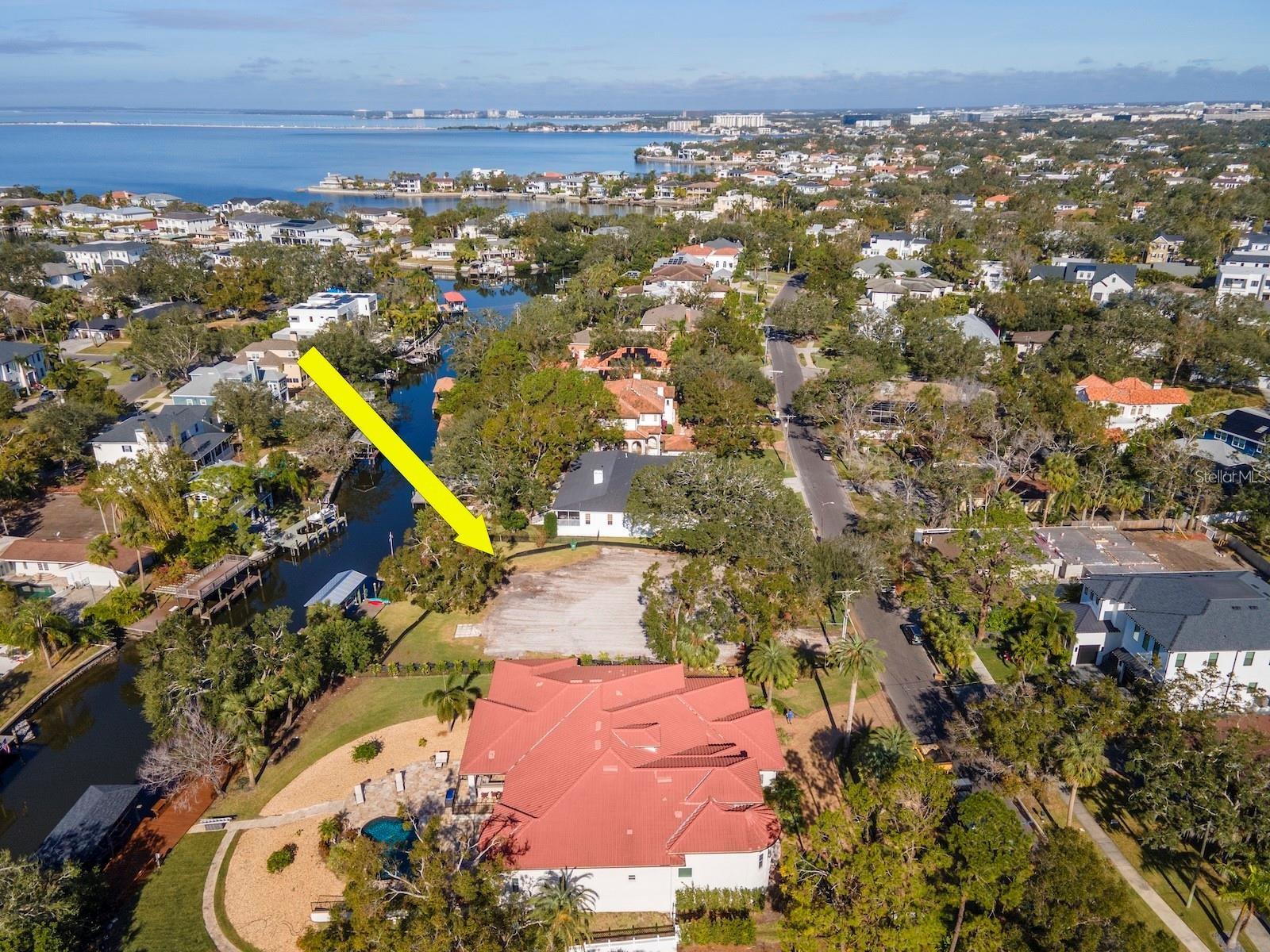 Welcome to your future land site to build your custom dream home located in prestigious Sunset Park. This oversized waterfront lot (22,115 sq. ft. almost 1/2 acre) 200 feet deep can accommodate a 10,000 square foot home and still provide a sizeable private parklike setting backyard. The land has been cleared for your convenience and includes a newly built 27 foot covered boat house with remote control and a separate loading and unloading dock. The boat lift can lift up to 8000 pounds of boat weight. Located on the N. Dundee River 3 minutes from the wide open mouth of Tampa Bay and minutes from the West Shore District where you can dock your boat while you dine and watch the sunsets. Navigation of these water ways are above average due to depth and width of the canal. Be prepared to experience and enjoy boating, fishing, and water sports as your daily lifestyle.  Let's don't forget the finest school choices both public and private are walkable distance along with a new playground down the street. The neighborhood has a traffic light allowing easy access to Westshore Blvd. The neighborhood of Sunset Park is a short distance to Tampa International Airport , International Mall , and Downtown Tampa.