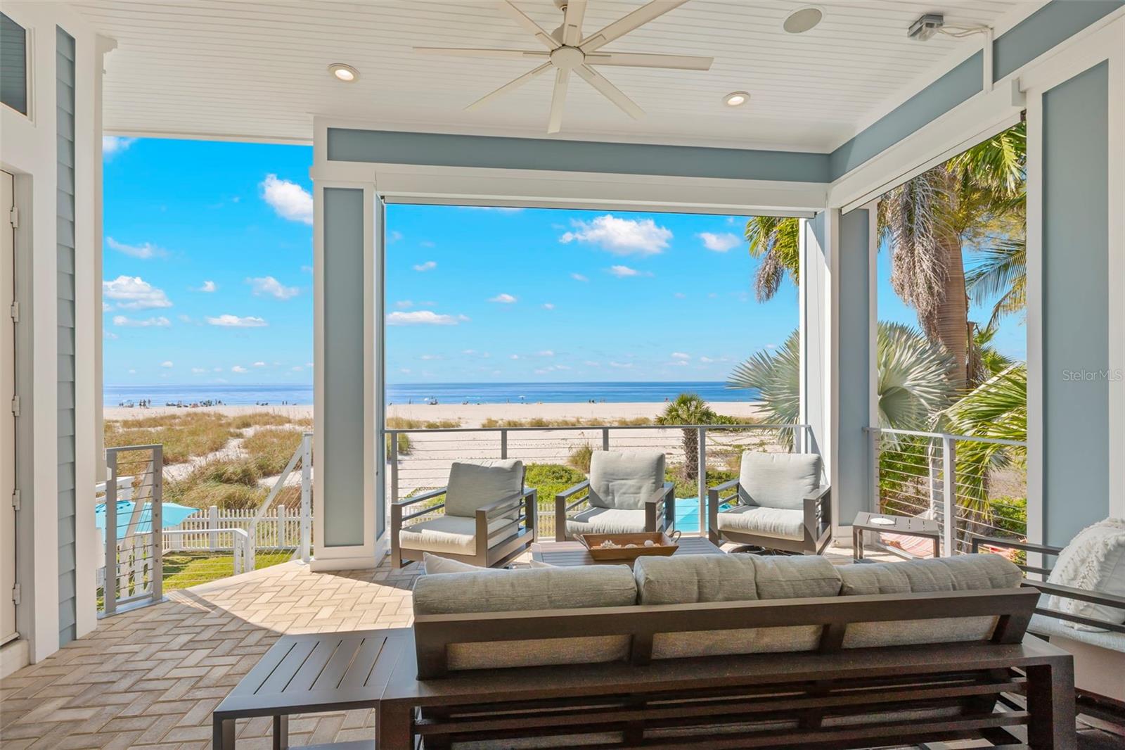 From Sunrise over the Intracoastal to Sunset on The Gulf, everything in between is simply magical!  Coastal Charm and Contemporary Elegance are gracefully combined within this Gulf Front Residence.  Ceilings soar over eleven feet to capture sunlight across architectural details and layers of texture.  Hardwood floors stretch from room to room in earthy driftwood hues.  Enter this Key West Styled residence through a stylish two story foyer with shell stucco walls and a private elevator reaching all levels.  A large gathering room draws you to the ocean, while the gourmet kitchen and formal dining room anchor you for entertainment flowing toward the beach side lanai.  Four spacious bedrooms, all with ensuite baths, provide comfort and privacy for residents and their guests.  The Primary Suite, on the top floor, has an office area, mini bar and private balcony overlooking the Gulf.  The Primary Bath has a jetted tub, double vanity and glass enclosed shower as well as two customized walk-in wardrobes.  The second and third bedrooms, also on the third floor, each have their personal ensuite baths and generous custom closets.  Full sized laundry room on this floor includes a laundry tub, built-in valet and large linen closet.  The fourth bedroom suite is on the main living level with doors opening to the front porch to enjoy sunrise views over the Intracoastal.  The sparkling Gulf Front Pool and Spa are heated for year-round enjoyment.  Chill and Grill on the covered lanai with a front row seat for Treasure Island’s world-famous sunsets!  Take a private path from the pool straight to the sandy shoreline and rinse off in your outdoor shower.  The attached garage has double and single overhead doors to accommodate three to six vehicles, bicycles or a golf cart.  This home is being offered fully furnished so you can start living your best beach life today!
