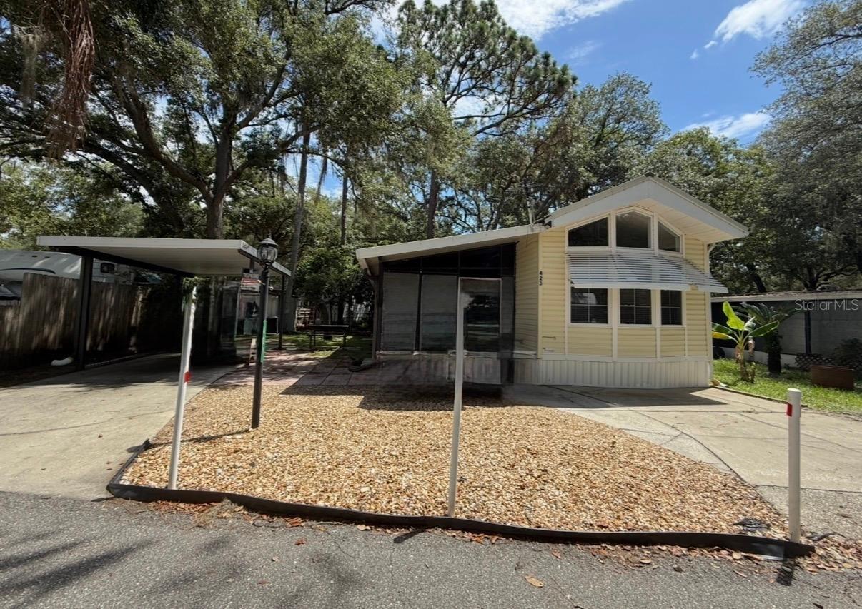 You own the land. No lot rent. This 2-bedroom 2-bathroom park model home with enclosed Florida room is located in central Florida near Orlando. Washer and dryer hook ups in utility shed. You are permitted to have two vehicles; there is plenty of parking space and a one car carport.  Upgraded ceramic flooring at entry-level and laminate flooring in park model, window treatments, ceiling fans and fixtures, large bay window in front living space adds natural lighting. The monthly Condo fees are only $283.30 which includes water, sewer, trash pickup, 24/7 virtual gatehouse, 110,000 gallon community swimming pool, on-Site Condo Office and Management, and maintenance of community grounds. Just pay your condo dues and metered electric bill for a prime location in sunny Florida. Clarcona road is very convenient to 414, 429 and 441 with lots of dining and shopping close by.