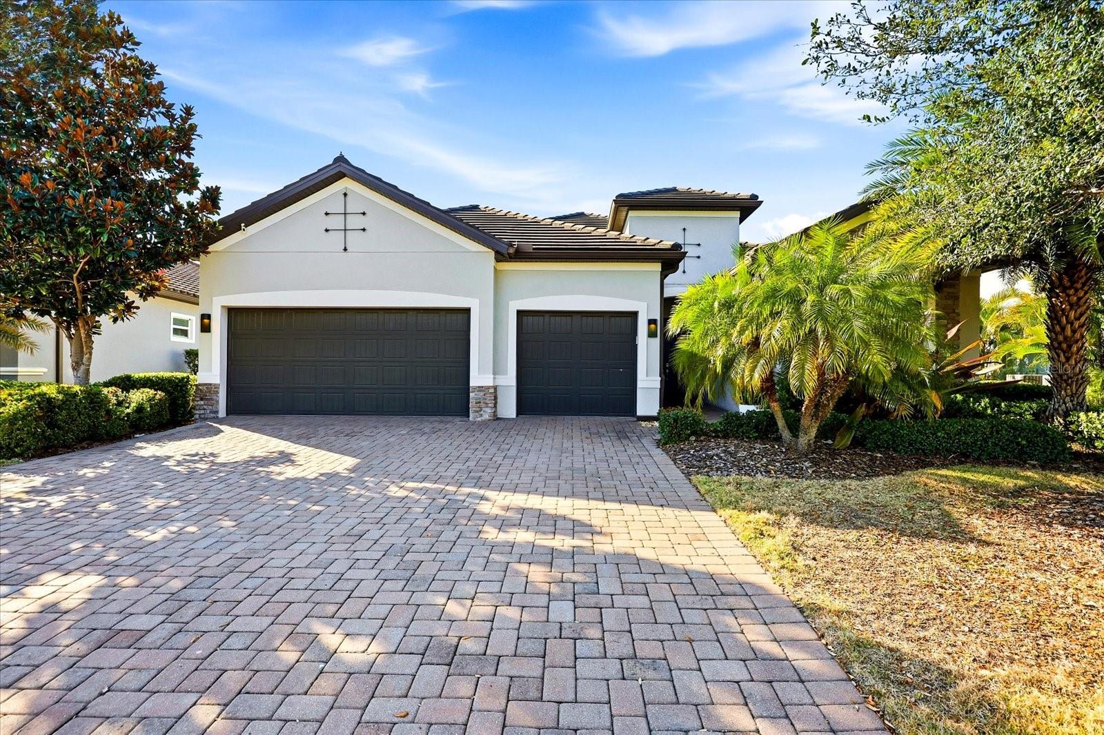 Welcome to this exceptional SUMMERVILLE POOL home in the gated community of ARBOR GRANDE at Lakewood Ranch, just steps from Bob Gardner Park. This beautifully maintained residence features 3 bedrooms, 3 full baths, PLUS PRIVATE DEN, and numerous upgrades that enhance both comfort and style. A screened front entry leads into a bright interior with 8FOOT DOORS 10 FOOT CEILINGS, custom built-ins, and elegant finishes. The den, enclosed by French doors, offers a perfect space for a home office or flex room. The open-concept layout seamlessly connects the living areas and extends to the outdoor space through triple sliding glass doors. The chef’s kitchen is equipped with stainless-steel appliances, a built-in oven and cooktop, pantry organization, and custom pull-out shelving for added convenience. The great room and dining area flow effortlessly to the lanai, creating an ideal indoor-outdoor living experience. Outside, enjoy a private WATERFRONT  setting with a screened, heated saltwater pool and spa overlooking a tranquil pond. Recent updates include a new pool heater and pump, upgraded lighting, re-screened lanai, and a refinished pool cage with rust-free fasteners. A gas OUTDOOR KITCHEN completes the space for easy entertaining. The primary suite features custom closets and a spacious bath with a walk-in shower. Guest areas offer comfort and privacy, with an upgraded secondary bath and custom window treatments throughout. Additional upgrades include storm shutters, fresh exterior paint, epoxy garage flooring, enhanced storage systems, updated lighting, and new appliances. An oversized three-car garage and access to Arbor Grande’s resort-style amenities—including a clubhouse, fitness center, pool, and private park access—complete the offering. Conveniently located near Lakewood Ranch Main Street, Waterside Place, UTC, and Gulf Coast beaches, this home delivers an exceptional Florida lifestyle.
