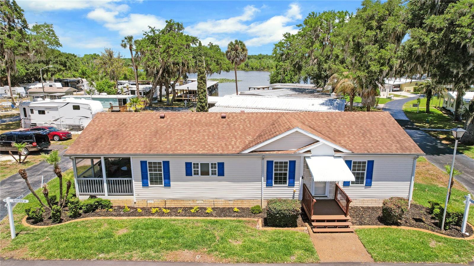 WHAT IF I TOLD YOU: $125 a month HOA fee included your WATER, SEWER, TRASH AND MOWING YOUR YARD!!! And yes there's more!! CHAIN OF LAKE ACCESS on Lake Griffin!! PRICE ADJUSTED TO SELL!  This community offers a marina and boat slips upon availability for a minimal fee.  It has a community fishing dock, pool, community building and so much more! This home is A RARE FIND 3 bedrooms, 2 bath beautiful home with split bedroom plan, open concept with an AMAZING KITCHEN! Ample cabinetry with closet pantry featuring pull outs, Counter space that goes on and on!! Inside laundry! And the most GORGEOUS SCREENED/COVERED LANAI! Spend your outdoor time overlooking a view of the water at the community boat ramp. Situated on a corner lot, One owner!  Reroof 2019, HVAC March 2026, HWH 2006 Don't miss this beautiful home in an active, low HOA community! See it and fall in love!