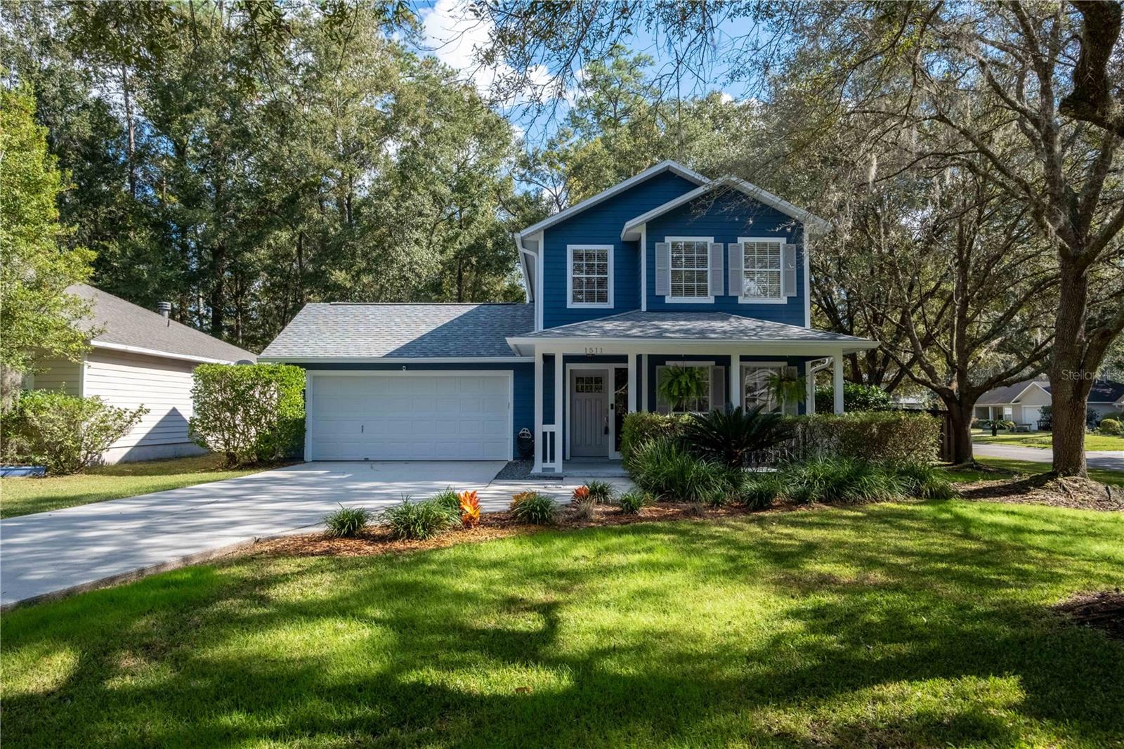 You can have it all - Picture Perfect curb appeal, amazing location, great schools and affordably priced!  With a freshly painted Hardi Board exterior in 2022, roof replaced in January 2023 and 2018 HVAC, this move-in ready home in Camden Park also boasts stunning Oak trees gracing the front and a movie set front porch where you can spend hours reading your favorite book.  All wood and laminate floors in the interior with no carpet is an added bonus.  Enter from the charming front porch into a formal foyer featuring a modern color palette and crown molding that extends to all public rooms and the owner's suite.  To the right of the foyer is a large formal dining featuring chair rail and crown molding.  If you have no need for formal dining, the area would be a perfect study.  A large inviting great room features an open plan to the kitchen, wood burning fireplace with wood mantel and brick surround, crown molding, new can lighting, and door to the screen lanai. The well-appointed kitchen features quartz counters, stacked stone backsplash, stainless appliances, an abundance of cabinets, and a spacious breakfast bar.  Downstairs is complete with a convenient half bath for visiting guests.  Upstairs features the owner's suite and 2 guest rooms.  The spacious owner's suite has laminate floors, crown molding and a large walk-in closet.  The en-suite owner's bath has a large vanity with 2 sinks with a dressing table area between plus a garden tub and separate shower.  Two large guest rooms with nice natural light, laminate floors, and good closet space serviced by a large hall bath completes the upstairs.  One of the highlights of the property is the over-sized screen lanai that overlooks the expansive fenced yard, a serene backdrop for outdoor living.  This lovely home is designed for both relaxation and entertaining, a perfect blend of modern convenience and classic charm.  Just a few blocks from Newberry Road and the Oaks Mall and so convenient to UF, I-75, shopping and restaurants.  Don't miss this opportunity to make this Camden Park home yours.