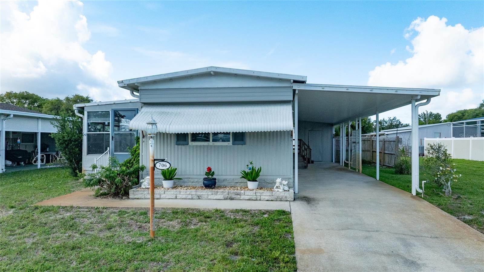 Located in the desirable Laurelwood 55+ community in Port Orange, this well-maintained 2 bedroom, 2 bath manufactured home sits on its own lot with an incredibly low HOA fee of only $25 per year. NOTE: Rentals are NOT allowed, helping preserve the quiet owner-occupied atmosphere that makes this community so appealing. One of the standout features of this home is the brand new metal roof installed in 2024, offering peace of mind and long-term value for the next owner. This 1979 home offers approximately 14x60 living space plus a spacious 10x20 glassed-in porch that adds valuable additional room for relaxing, entertaining, or enjoying Florida living year-round.

The property also features a nice covered carport, siding, carpet and laminate flooring, updated white double-pane windows, and both bathrooms have been updated. The central A/C was replaced in 2014 and the water heater in 2016. There is also a storage shed with washer and dryer included.
Laurelwood is conveniently located near shopping, restaurants, medical facilities, parks, and just a short drive to the beaches, riverfront areas, and everything the greater Daytona Beach area has to offer. Whether you are looking for a full-time residence or affordable seasonal living, this property is priced aggressively and presents an excellent opportunity in today's market.