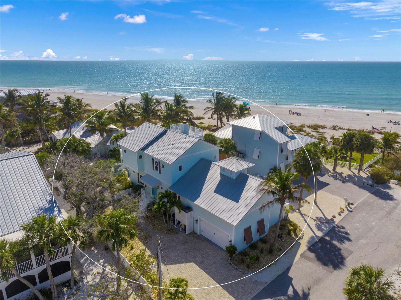Beachfront Bliss – Gulf Views from Every Angle!  
Just one house from the beach, this 4-bedroom, 4-bath coastal stunner delivers postcard-perfect Gulf views straight from the kitchen sink—yes, you’ll actually smile while scrubbing plates!  Natural light throughout, high ceilings, 2 sided fireplace, wet bar in the living room, open living area that flows into a chef’s kitchen.  Stainless steel appliances, gas stove, double ovens and more!  The coastal chic blue countertops and tile throughout for easy beach sand clean up!  Step outside to your wrap around balcony to dine and enjoy the gulf breeze. Backyard features your private heated pool that includes a sun shelf.    All the bedrooms are spacious and have their own privacy.  The primary suite is upstairs with even better views of the Gulf to wake up to.  Enjoy your private balcony AND a spiral staircase leading up to the roof top deck, ideal to watch sunsets and dolphins jump in the water.  Master bathroom has a huge walk-in shower, soak in tub, dual sinks and a large walk-in closet that includes a safe.  The location is central to the island, close to everything and very convenient.  30 day minimum rental period.  
One house away from the Gulf, this may be the island’s best-kept secret!