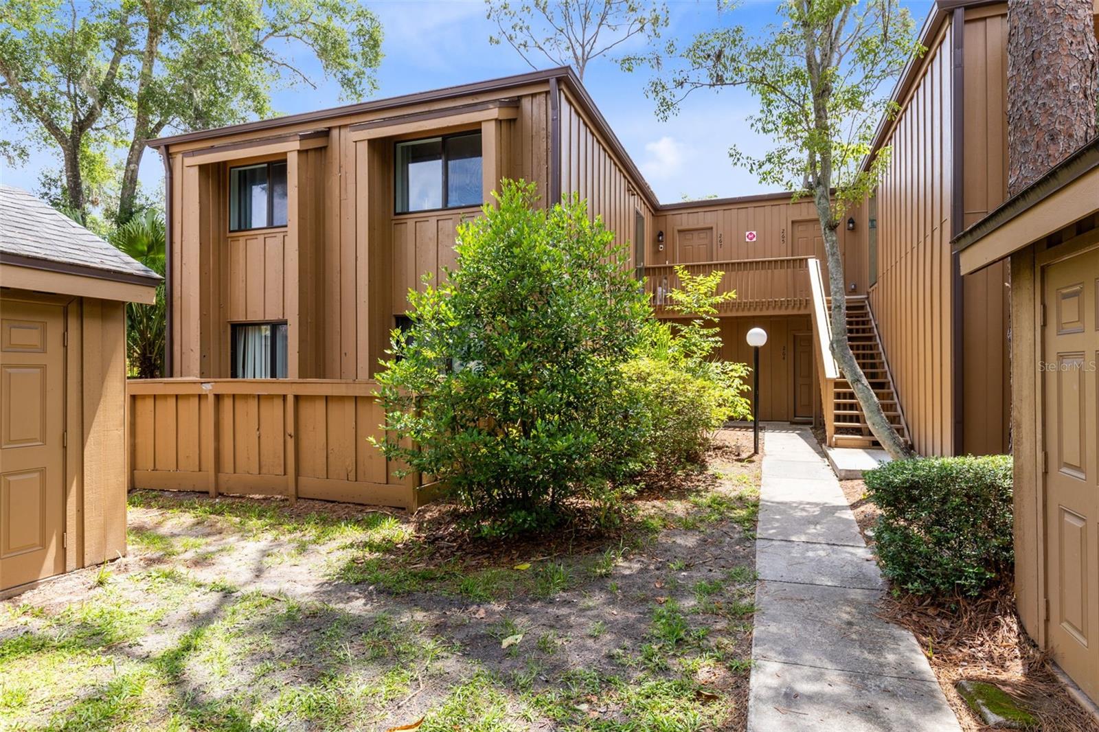 This LIKE NEW 2 bedroom 2 bathroom condo is the hidden gem you've been looking for! It's been rewired, repiped, 2025 AC with Reme Halo air purifier & so much more! With a low-maintenance lifestyle, all new major systems and finishes plus amenities galore all behind a manned-guard gate, what more could you want? Living in The Springs feels like stepping into a hidden nature preserve tucked right into the heart of Longwood. This gated community is known for its winding, tree-canopied roads, peaceful walking trails, and the rare natural spring that becomes the backdrop for everyday life. Step inside and you'll find lots of sunny spaces, a foyer entry with drop station, luxury vinyl floors throughout and a gorgeous kitchen that will want to spend time in with lots of cabinets for storage, ample quartz countertop for cooking and prep, stylish open wood shelving, stainless steel appliance package with matching hood and window over sink offering nature views! Off kitchen is a utility room/bonus space with pantry storage, washer/dryer and more counter space! Enjoy meals in the separate dining room that flaunts a charming light fixture and picture window! With a refined yet cozy feel, the living room has 13ft soaring ceilings with wood details and beam plus transom windows for all of the natural light lovers anda large sliding glass door making the room feel more open! Primary retreat includes a wall of built-in closets and an en-suite designer-style bath making the everyday routine feel fun with hex tile floor, sleek tiled shower stall with frameless barn-style door & chic vanity with stone! Stylish secondary bath has a classic black and white color scheme with subway tiled tub/shower combo and lots of modern touches! This property is just steps from the newly refurbished community pool, has a 1 car carport and several guest parking spots nearby. In addition to the natural Spring,  this community offers a beach like area to hang out and spend your weekends, clubhouse available for private parties, brand new pickelball/tennis courts, basketball courts, horse stables, lots of walking trails, a community pool and lots of community events. The Springs offers a retreat-like way of living while still being just minutes from shopping, dining and top-rated Seminole County schools. It’s one of those places where life naturally slows down and coming home truly feels like an escape. You owe it to yourself to see this one!
