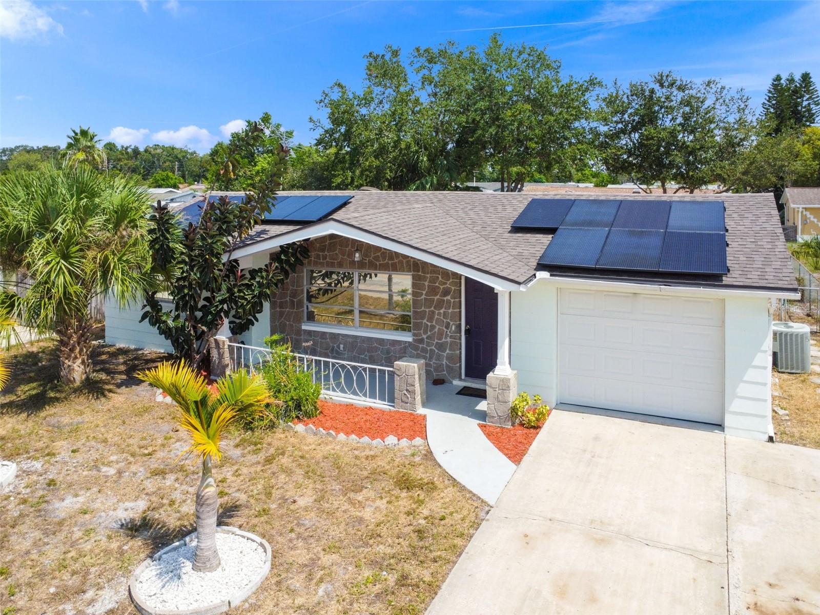 *****SELLER OFFERING 3% OF THE PURCHASE PRICE TOWARDS CLOSING COSTS/PRE-PAIDS.***** YOUR FLORIDA HOME AWAITS! MOVE-IN READY! 2 bedroom with a bonus room. This house has MANY upgrades including a 2 year old roof, newer AC, and 2021 solar panels. Open concept living area is spacious and open. This home was newly remodeled in 2021 with beautiful white cabinetry and sparkling granite countertops. This home is equipped with oversized solar panels meant for a 3000sqft + home. Electric bill is under $40 and is only a charge to have power connected. THESE PANELS WILL BE FREE AND CLEAR AT CLOSING (a 60k value)! Enjoy the covered front porch or retreat to the rear covered, screened-in porch. Water pipes replaced with new PEX piping. Extra bathroom contains a brand new toilet and shower. Newer garage door. This home is move-in ready or can be utilized as a turn-key rental. Less than five minutes from a boat launch into Gulf waters. Minutes from the historic Tarpon Springs sponge docks. NO HOA, NO CDD, NO FLOOD INSURANCE REQUIRED!