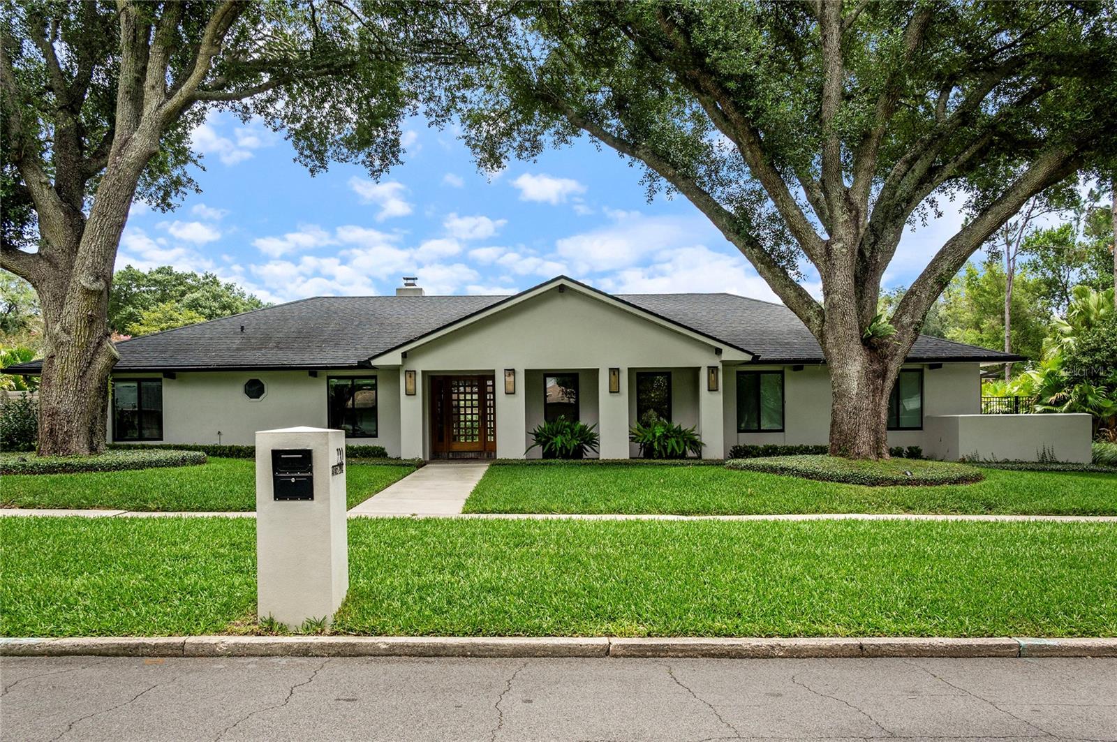 Welcome to 220 Adams Drive — a breathtaking, completely remodeled single-story masterpiece nestled in the heart of Maitland's coveted Kings Row neighborhood. Thoughtfully reimagined from the studs out with exquisite craftsmanship and elevated design, this stunning home offers 4 bedrooms, a dedicated private office, 3.5 baths, and over 3,000 square feet of refined living on a fully fenced, oversized lot.

The renovation is truly comprehensive — all-new plumbing, electrical, ductwork, and three separate AC units provide complete peace of mind. Spray foam insulation delivers exceptional energy efficiency, propane gas powers the chef's kitchen cooktop and tankless hot water heater, and Lutron touch-slide dimmers indoors plus automated Lutron outdoor lighting give the home a level of sophistication and control that is rarely found at any price. French drains round out a property that has been engineered as thoughtfully as it has been finished.

Step through a charming covered front porch and into a bright, open-concept interior where elevated ceilings, rich wood floors, and designer recessed lighting create an effortlessly elegant atmosphere. The chef's kitchen is a showstopper — outfitted with high-end appliances including a gas cooktop, custom white cabinetry, clever appliance garages, and bespoke built-ins that marry beauty with function. The warm and inviting living room anchors the home with a wood-burning fireplace and seamless sliding doors to the pool beyond.

The split-bedroom layout offers exceptional privacy for every member of the household. The oversized primary suite features a spa-inspired en suite with a double-sink vanity, walk-in glass shower, and soaking tub — plus a large walk-in closet with custom built-ins. The second bedroom enjoys its own private en suite with a walk-in shower, perfect for guests or multi-generational living. Bedrooms three and four share a well-appointed hall bath with a tub/shower combination.

Outside, your private resort awaits. The saltwater pool with sunshelf is the perfect centerpiece, framed by a covered cabana with fireplace and a fully equipped outdoor kitchen. The Lutron automated lighting system extends seamlessly to the exterior, creating effortless ambiance day and night. The fully fenced yard offers privacy and room to breathe.

The property features a two-car garage and a separate one-car garage — both finished with epoxy floors. The one-car garage is currently appointed as a private home gym with an adjacent storage room, offering flexible utility from day one.

Located in a quiet, tucked-away neighborhood with a community park and playground, this home is just minutes from Winter Park, Park Avenue, the Winter Park Racquet Club, and scenic parks and trails. Zoned for top-rated Dommerich Elementary, Maitland Middle, and Winter Park High School.

Homes of this caliber — fully rebuilt, impeccably finished, with every system new — are extraordinarily rare. Schedule your private showing today.