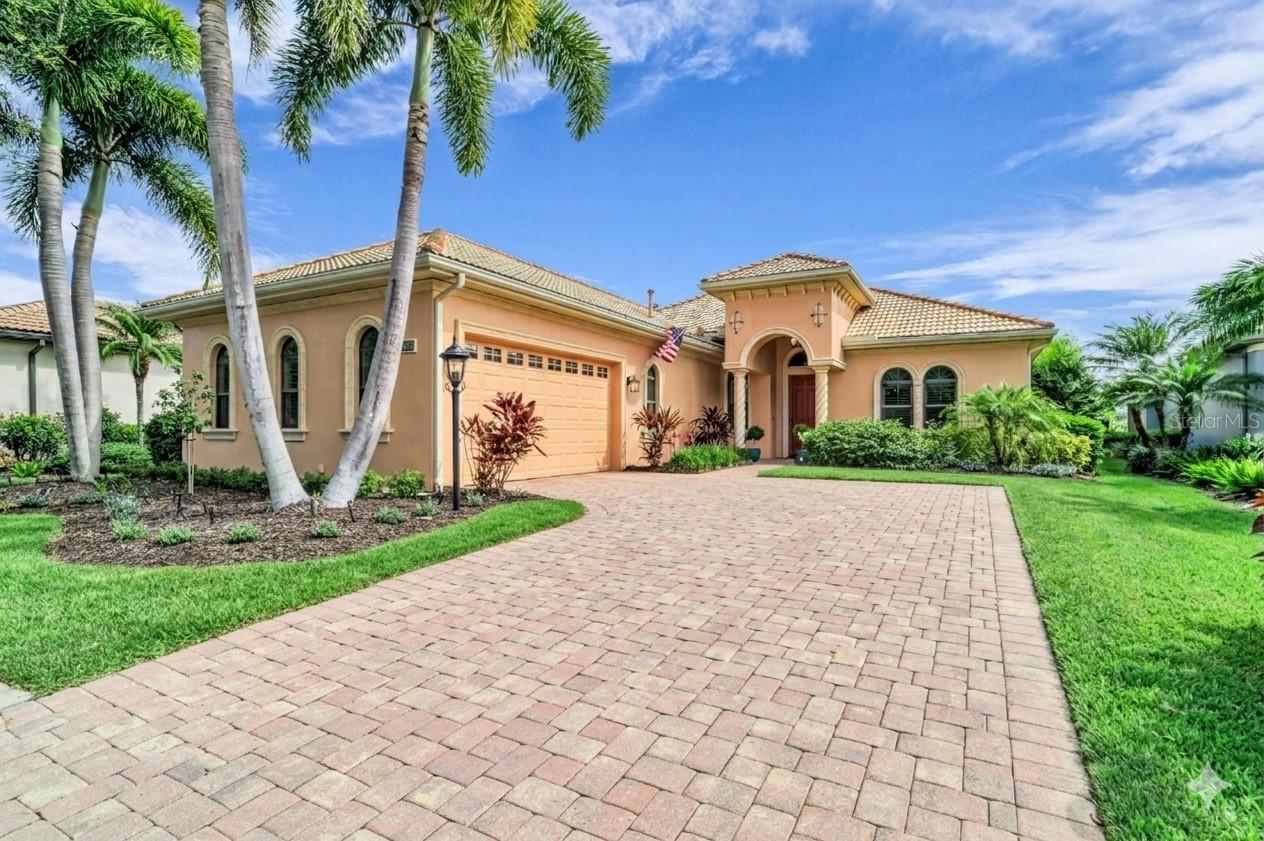 Welcome to Your Lakewood Ranch Sanctuary
Imagine starting your morning on the expansive lanai, a freshly brewed cup of coffee in hand. As the sun rises over the private golf course, the world is quiet except for the cheerful chorus of local birds greeting the day ahead. This isn’t just a dream vacation—it’s your everyday reality at this exquisite custom home, nestled in the exclusive, maintenance-free neighborhood of Leopard Creek in Country Club East.
From the moment you step inside, this meticulously designed residence blends elegance with effortless functionality. You are greeted by an airy, open floor plan grounded by stunning travertine flooring that flows through the main living areas and the private office/den (which can easily serve as a third bedroom). Peace of mind is built right into the framework, with premium hurricane windows throughout ensuring safety and absolute tranquility.
A Chef’s Dream & Seamless Entertaining
At the heart of the home is a kitchen designed to inspire your inner chef. It features soft-close wood cabinetry, high-end appliances—including a Subzero refrigerator and a Wolf gas cooktop—and a massive, one-level center island with seating that naturally draws everyone together.
When you entertain, the living space truly transforms. The heavy glass sliders pocket completely into both sides of the wall, seamlessly erasing the line between indoors and out. Your living room flows directly into the covered outdoor oasis, complete with a fully equipped outdoor kitchen, a sparkling heated pool, and panoramic golf course views. There is even a convenient powder bath with direct lanai access for wet swimsuits. Luxurious Private Retreats
When the day comes to a close, retreat to the luxurious primary suite. This private sanctuary boasts a dramatic tray ceiling, its own direct access to the lanai, and a spa-like bath featuring dual sinks, a massive walk-in shower, and an expansive walk-in closet.
Every detail has been considered for maximum convenience:
Accommodations: A spacious second bedroom and an elegant second full bath for comfort for family or guests.
Utility & Storage: The laundry room is a powerhouse of efficiency, loaded with custom cabinetry, a utility sink, and an additional refrigerator.
Garage Space: A side-load, oversized two-car garage provides plenty of room for vehicles plus an extra walk-in storage room. The Ultimate Lifestyle Community
Living in Leopard Creek means embracing a lifestyle that is both active and deeply connected. Beyond the resort-style amenities of Country Club East—which include three community pools, a state-of-the-art fitness center, and a beautiful club room—you will love the tight-knit warmth of your immediate enclave. Here, you can fill your social calendar and form lifelong friendships by enjoying all the vibrant monthly activities put on exclusively by the neighbors of Leopard Creek.
Located just moments away from Sarasota’s world-class dining, entertainment, and cultural offerings, as well as A+ rated schools, pristine Gulf beaches, and top-tier medical facilities, this property is more than just luxury living at its finest. It is the place you will truly want to call home. Please note: HOA is quarterly not monthly as the real estate websites show.
