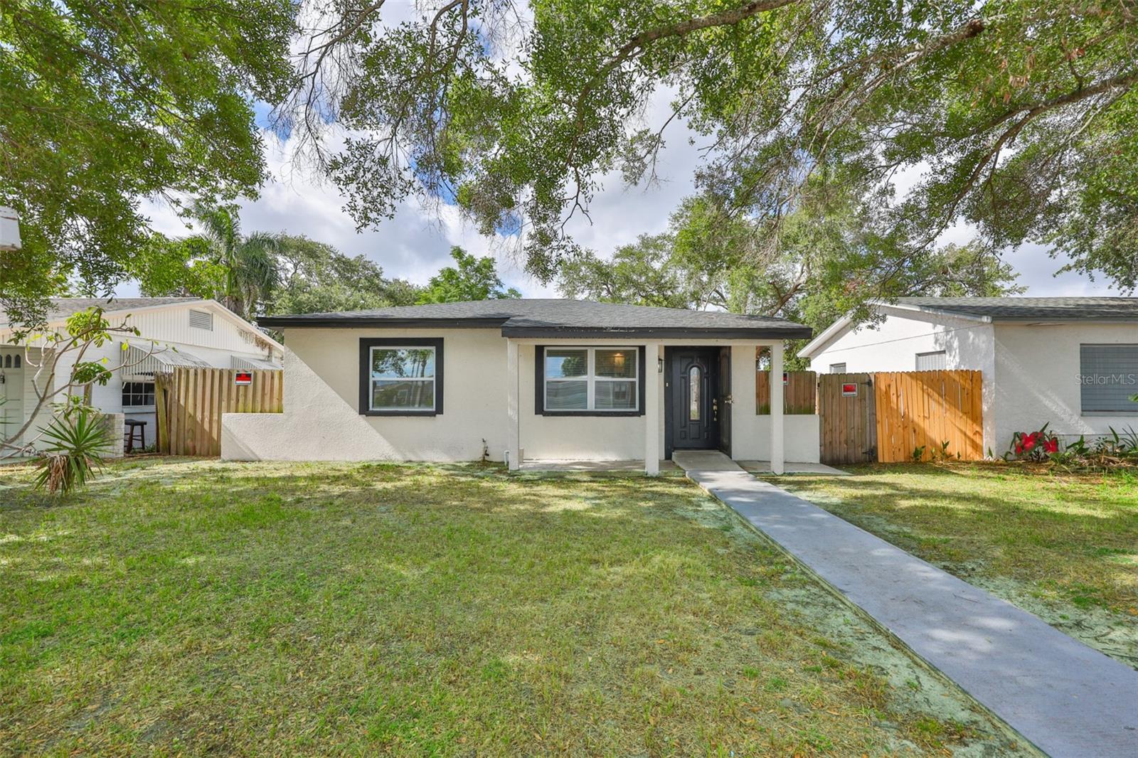 This thoughtfully updated 4-bedroom, 2-bathroom home at 2450 40th Ave N offers the perfect blend of modern comfort and classic Florida living on a generously sized, fully fenced lot in a sought-after St. Petersburg neighborhood. Listed at $349,000, this 1,400-square-foot residence feels immediately welcoming, with fresh interior and exterior paint that bathes every room in natural light and a sense of calm. Step inside to discover a completely refreshed kitchen featuring updated countertops and abundant cabinetry, creating an efficient space for everything from quiet morning coffee to lively gatherings with friends. The thoughtfully designed layout provides flexible living areas, easily accommodating a formal dining space, intimate seating nook, or expansive living room that adapts to your lifestyle, whether you're relaxing after a long day or entertaining guests. Privacy and practicality shine through in the split-bedroom floor plan, while the new roof (2021) and updated HVAC system (2021/2022) deliver peace of mind for years to come. Outside, the fully fenced yard invites cherished moments, whether watching children or pets play, tending to a garden, or simply unwinding under the Florida sky. With ample outdoor space, the property holds exciting potential for future expansions or even a private pool. Conveniently positioned near local parks, excellent schools, inviting dining options, and the vibrant energy of downtown St. Pete, this home places everyday convenience and weekend adventures at your fingertips. Don't miss the opportunity to make this move-in ready gem your own.
