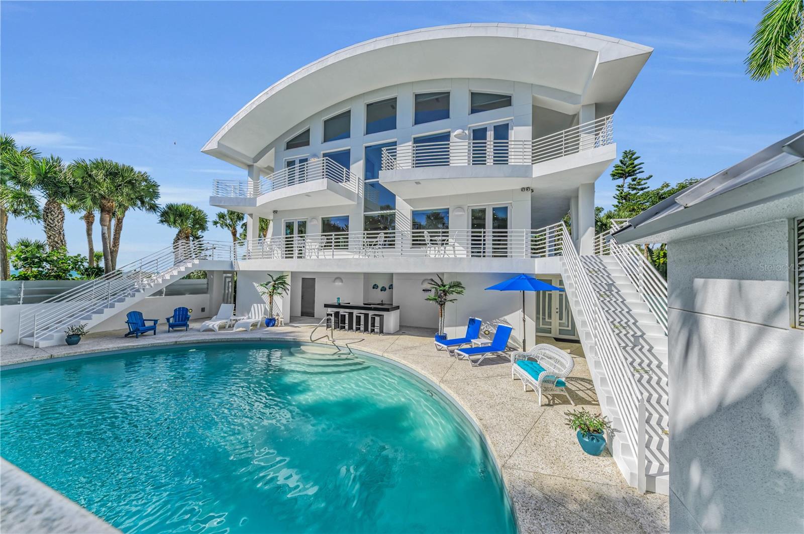 773 North Manasota Key Road is uniquely positioned between Lemon Bay and the Gulf of Mexico, offering a lifestyle defined by water, light, and ease. Mornings begin with sunrise over the Bay, while afternoons naturally draw you toward the Gulf just steps away—creating a daily rhythm shaped by the setting rather than a schedule. The arrival experience is private and intentional. Mature coastal landscaping frames the home, providing natural screening while anchoring the architecture within its surroundings. The transition from outdoors to in feels seamless, thoughtful, and composed. Inside, the home reflects understated luxury. Finishes were chosen for quality, durability, and timeless appeal—materials that feel substantial and appropriate to a coastal environment. The floor plan flows effortlessly, with balanced proportions and clear sightlines that support both comfortable everyday living and refined entertaining. Natural light moves easily through the home, and indoor-outdoor connections are intuitive rather than forced. Beyond beauty, the residence is designed for confidence and peace of mind. Impact-rated windows and doors, a whole-house generator, and thoughtfully engineered systems allow the home to operate securely and reliably, contributing to comfort and confidence in a coastal environment Architecturally, the home is restrained and enduring. Details are revealed gradually, rewarding those who value craftsmanship, thoughtful design, and a sense of permanence. Every element feels purposeful, as though the home has always belonged on this stretch of Manasota Key. This property offers a rare balance of privacy, security, and serenity—an experience best understood in person. 773 North Manasota Key Road is not a statement home. It is a confident one—timeless, intentional, and designed to be lived in fully.