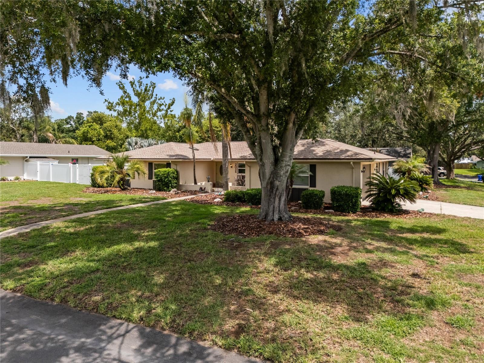 Spacious 4-bedroom, 2-bath ranch-style home offering 2,228 sq. ft. of comfortable living space on a desirable corner lot in Lakeland, Florida. This well-maintained home features a formal living room, formal dining room, family room, and eat-in space in the open kitchen, providing plenty of space for entertaining and everyday living.  The kitchen includes a pantry, newer refrigerator, stainless steel double-oven range, dishwasher, and abundant storage. Interior updates include fresh paint throughout, new carpeting, and a brand-new roof installed in June 2026.  Large closets in bedrooms and Primary has en-suite his and her closets.  Linen closet in Primary for that added storage dream.  Step outside to your private backyard retreat featuring an inground pool with screened enclosure, expansive deck area, landscaped views, and a fully pvc-fenced yard. Pet owners will appreciate the convenient doggie doors. Two double gates provide easy access to the large backyard, which also includes a storage shed for lawn equipment, tools, or recreational items.  No HOA allows buyer's inspirations to come true or room for a boat, etc.  Additional highlights include tile, laminate, and carpet flooring, a two-car garage with storage shelving, and a wide driveway for extra parking.  AC is 2024 and Water Heater is 2022.  Conveniently located near hospitals, shopping, restaurants, and the Polk Parkway, offering easy access to Tampa, Orlando, Disney World, and surrounding Central Florida attractions. This move-in-ready home combines space, functionality, and offers desirable Lakeland location.