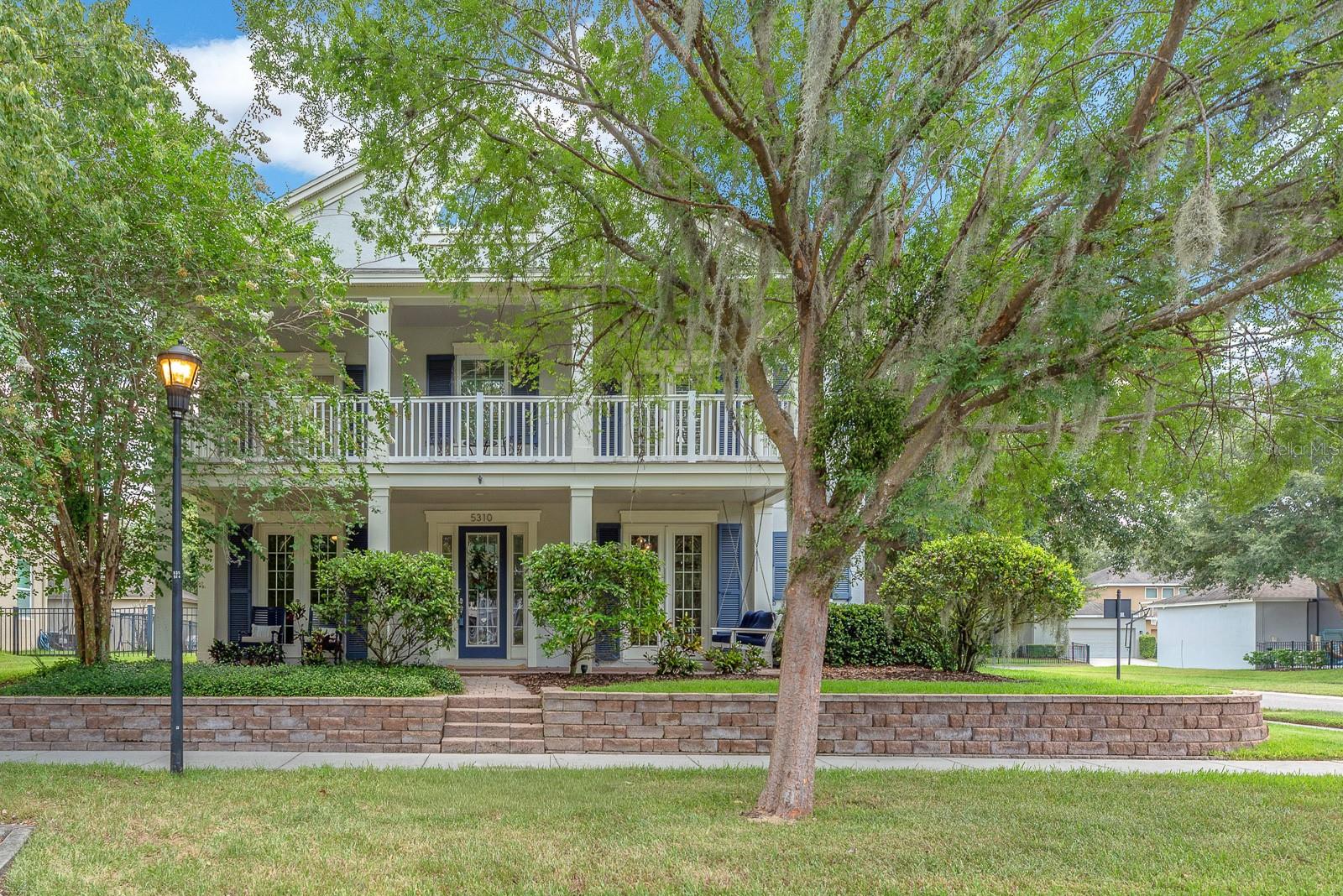 Set on a large corner lot in Starling at FishHawk Ranch, this beautifully designed two-story home brings together timeless architecture, thoughtful upgrades, and the feeling of home that begins before you ever step inside. A wide front porch, tree-lined setting, and welcoming streetscape creates an inviting, neighborhood-connected feel, while the fenced yard, covered rear porch, and detached rear-entry 3-car garage add everyday function behind the scenes.
Inside, the home feels both refined and comfortable, with soaring two-story ceilings in the main living area, warm wood flooring, ceramic tile, crisp white walls, and rich contrast from dark cabinetry, metal railings, designer lighting, and color-drenched accent spaces. Formal living and dining areas offer flexibility for a den, library, office, or game room, giving the home room to adapt without losing its sense of style.
The kitchen is designed to be both beautiful and highly usable, featuring upgraded stainless appliances, rich wood cabinetry, an oversized island with storage, stone counters, pendant lighting, and an open connection to the main living and dining areas. A butler’s pantry, mudroom, half bath, and additional storage spaces add the kind of practical details that make the home feel as effortless as it looks.
Upstairs, the home continues with 4 bedrooms and 3 full baths, including two secondary bedrooms connected by a Jack-and-Jill bath and another with its own en suite, offering comfortable privacy and flexibility. A second-floor balcony extends the living experience outdoors, creating a quiet place for a slow Saturday morning or mid-week wind down. The primary suite offers a private retreat with balcony access, a spacious bath, and a layout that feels calm, open, and elevated. Smart home features, extensive upgrades, and a cohesive designer finish give the home a polished, move-in-ready presence.
Located in Starling at FishHawk Ranch, the home is in one of the areas most desired communities, known for its parks, trails, recreation areas, top schools, and resort-style amenities. Elegant, practical, and full of thoughtful design, this is a home that leaves an impression from the moment you arrive. Schedule your private tour and experience it in person.