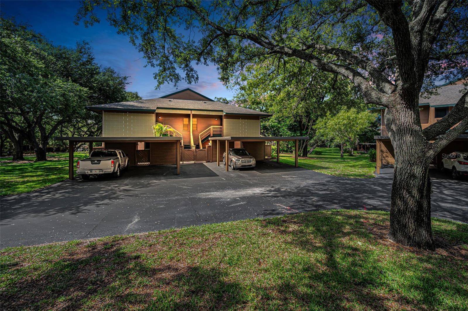 Located in the desirable GLENEAGLES community in PALM HARBOR, with TREE-LINED STREETS and a peaceful setting, this well-maintained one-bedroom, one-and-a-half-bath END UNIT condominium offers comfort, convenience, and a relaxed Florida lifestyle. A PRIVATE FRONT PATIO welcomes you, while the SCREENED REAR PORCH provides a peaceful setting overlooking beautiful mature trees. The COVERED CARPORT includes a convenient storage room for your extra belongings. Inside, the FRESHLY PAINTED interior features LUXURY VINYL PLANK FLOORING throughout and an IN-UNIT WASHER AND DRYER for added convenience. The spacious living room flows into the dining area, creating an inviting space for everyday living and entertaining. In addition to the living and dining rooms, this home offers a versatile bonus room complete with a closet that could be used as home office, den, hobby room, guest space, or reading retreat. The primary bedroom features TWO CLOSETS and an EN-SUITE BATH. The home's unique split bath design includes a centrally located tub and shower that is accessible from both sides, with the primary bath on one side and a separate guest half bath with its own vanity and toilet on the other. This thoughtful layout provides both privacy and convenience for homeowners and guests alike. Mature tropical landscaping enhances the property, with fragrant Jasmine and Gardenia in the front courtyard and vibrant flowering plantings along the side yard, adding color and charm to the outdoor spaces. Gleneagles residents enjoy access to a COMMUNITY POOL, CLUBHOUSE with monthly social events, and TENNIS and PICKLEBALL COURTS. The monthly fee includes building exterior maintenance, lawn care, basic cable, water, sewer, trash, and use of the community amenities. This is a PET-FRIENDLY community that allows up to two pets. Ideally located just 4 miles from historic downtown Palm Harbor, residents can enjoy a charming small-town atmosphere with local restaurants, community events, and easy access to the scenic Pinellas Trail. This is also just 2 miles from Innisbrook Golf Resort, home of the Valspar Championship. Spend the day exploring the natural beauty of Honeymoon Island State Park, located just 9 miles away, where you can enjoy pristine beaches, nature trails, kayaking, and spectacular Gulf sunsets. World-famous Clearwater Beach is only 16 miles away. Tampa International Airport is approximately 20 miles away, making travel and welcoming out-of-town guests a breeze. This inviting home offers the perfect opportunity to enjoy the best of Florida living in a convenient Palm Harbor location!